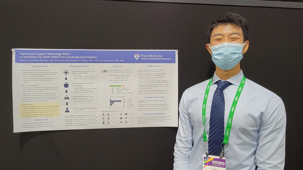 Tyler Lian standing in front of a scientific poster with information about the FAST project