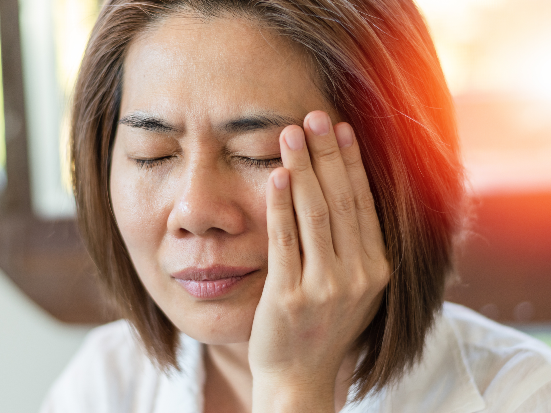 Temporomandibular Joint and Muscle Disorder. Asian woman hand on cheek suffering from jaw pain or toothache