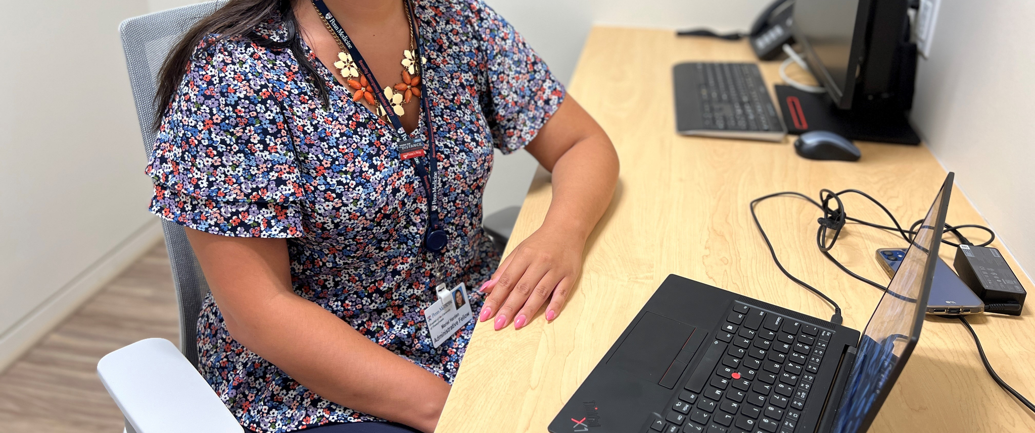Mariel Harden seated at a desk in front of a laptop