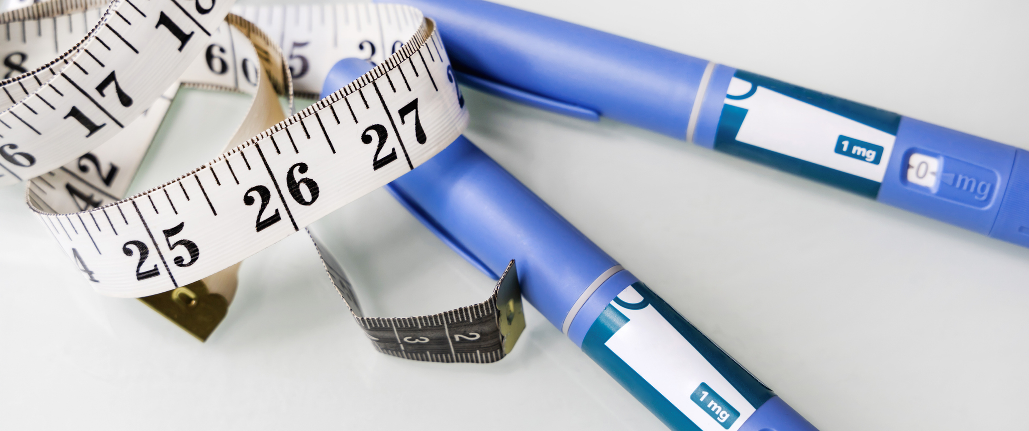 A GLP-1 injection pen is shown wrapped in measuring tape
