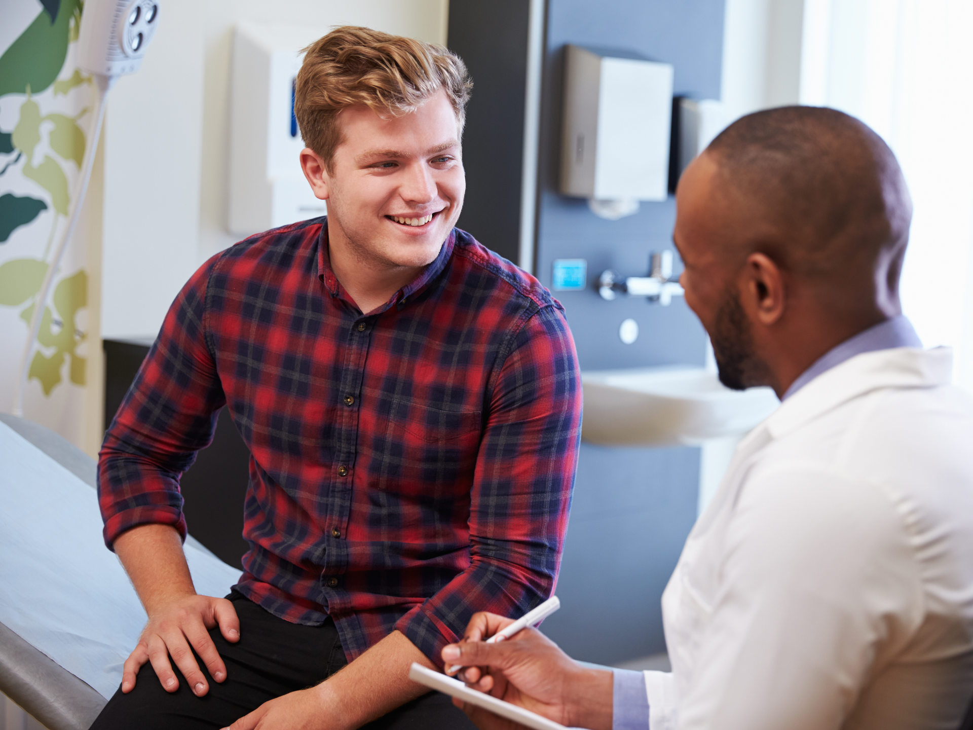 Male patient and doctor have consultation In hospital room