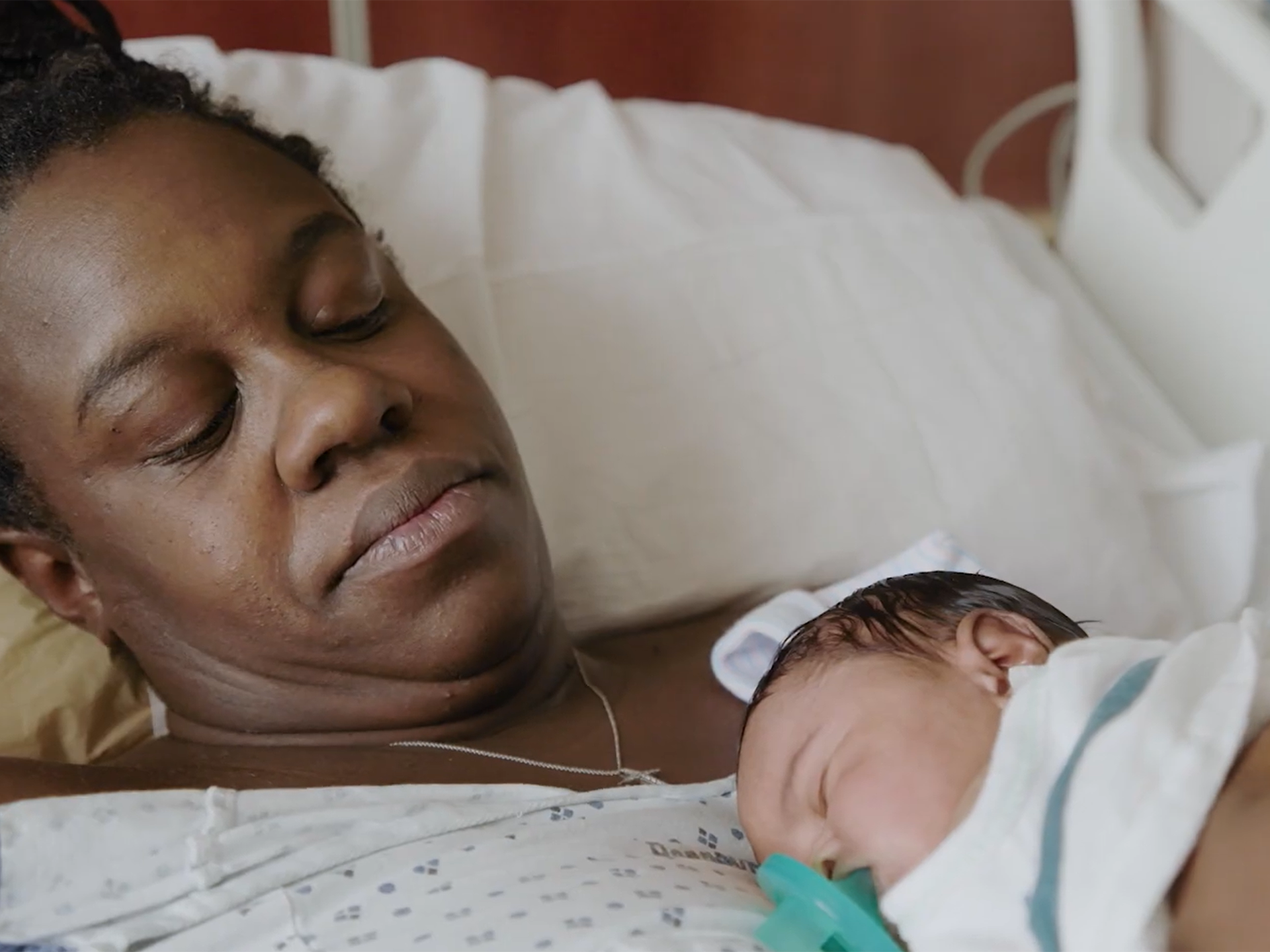 Woman holding hr newborn after delivery a the maternity