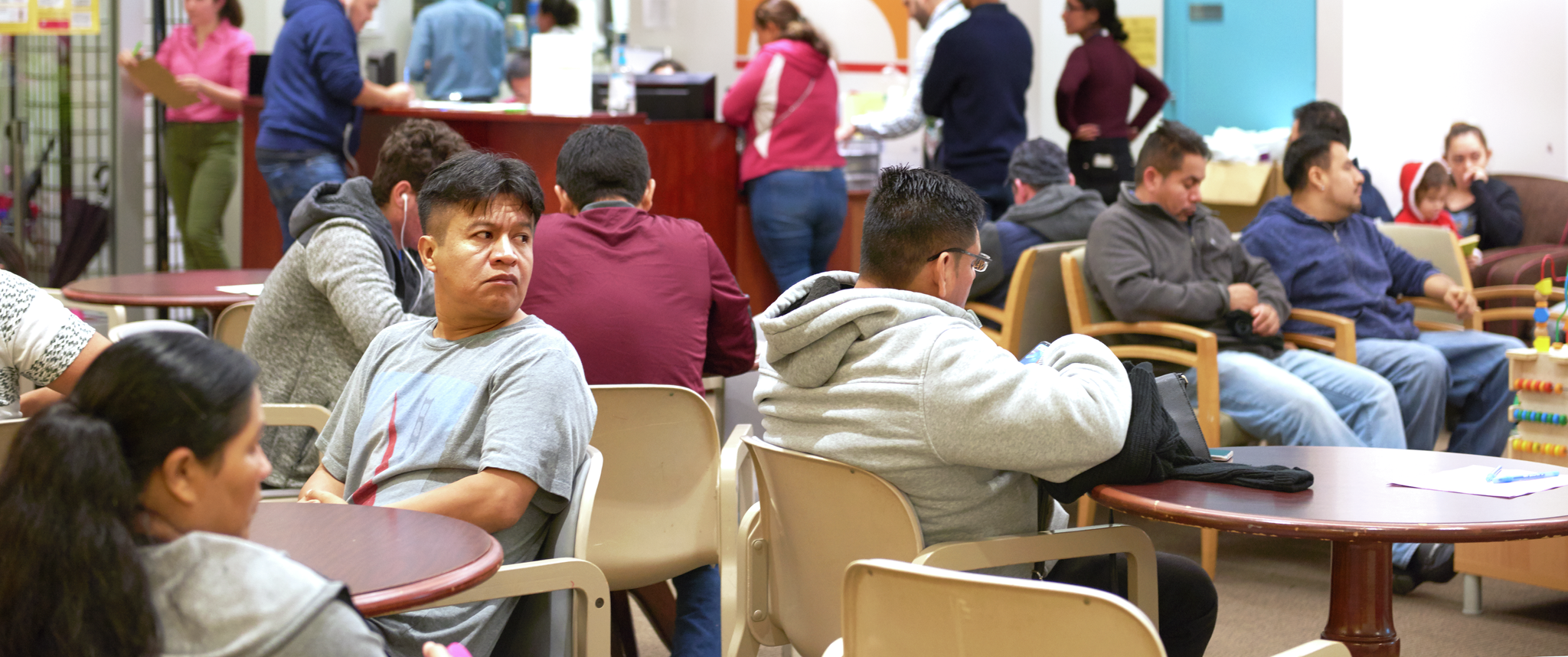A crowded and bright waiting room at Puentes de Salud