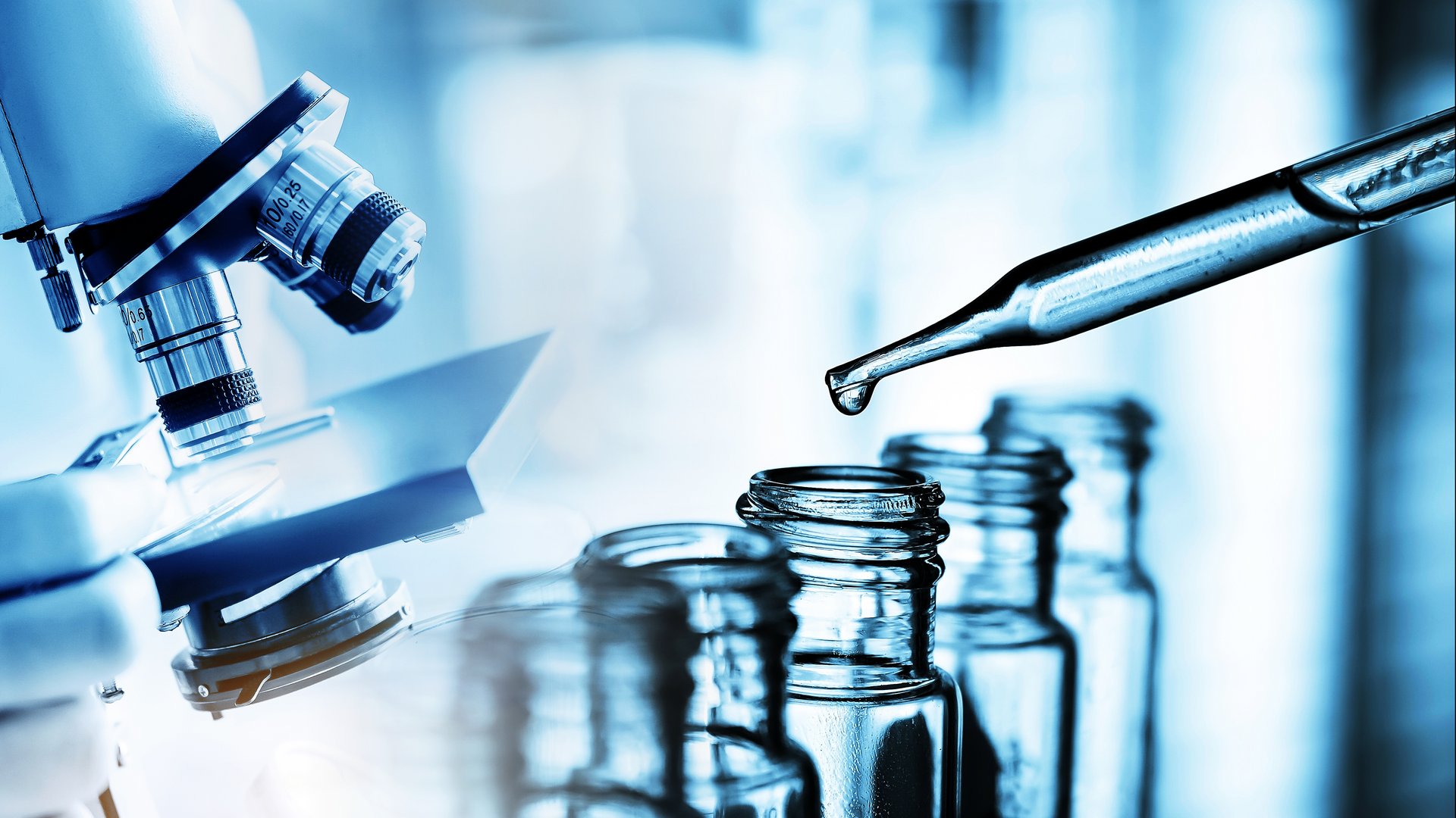Hand of scientist holding flask with lab glassware in chemical laboratory background