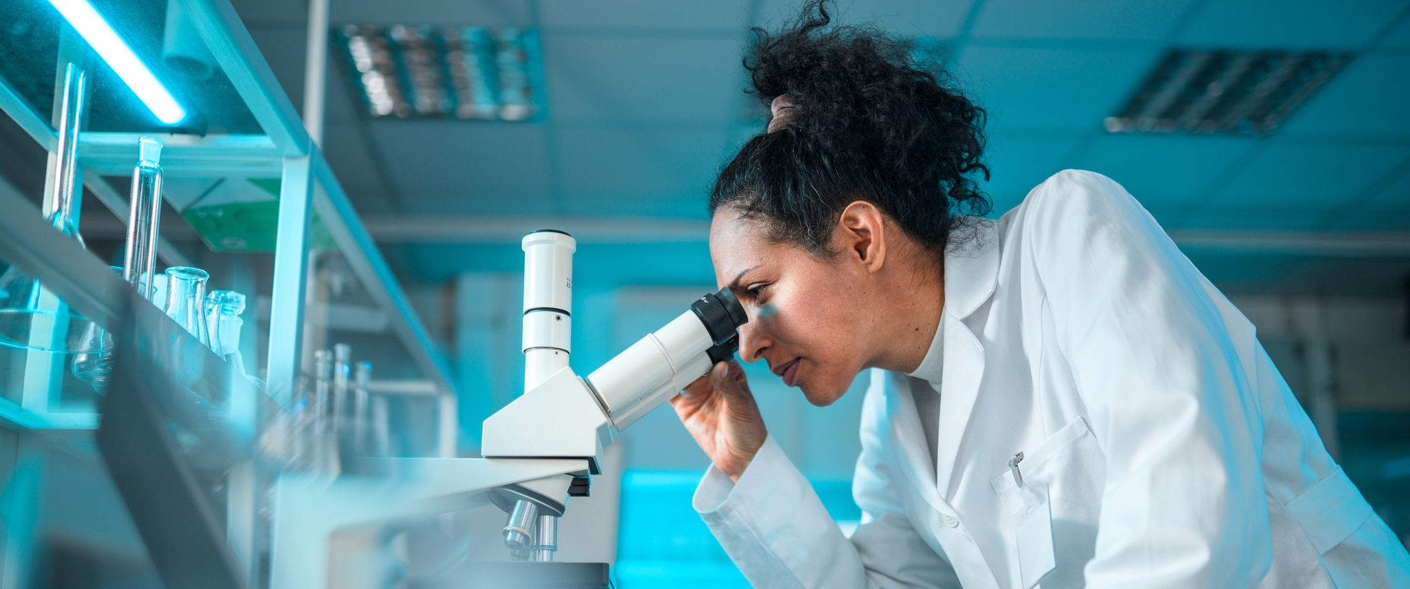 Female Pharmacist Looking Through a Microscope