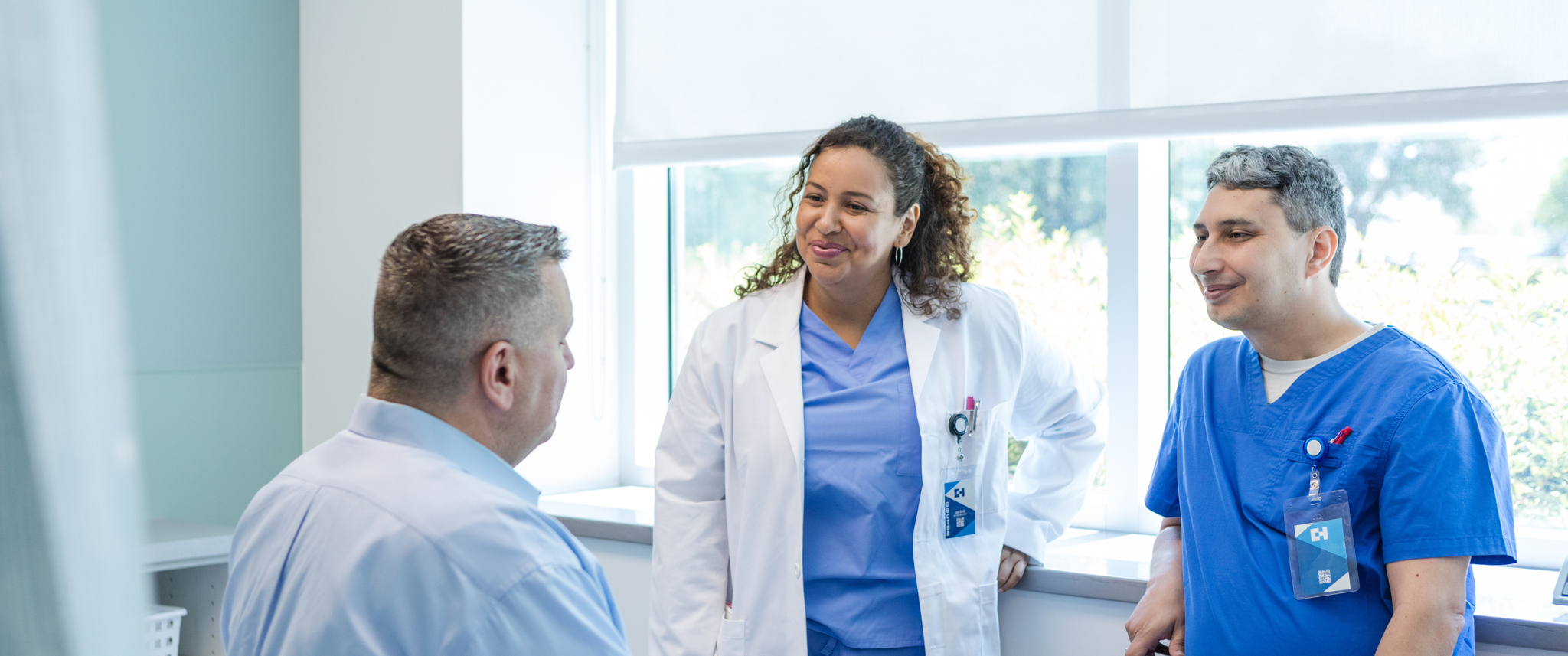 Two physicians speaking to a male patient