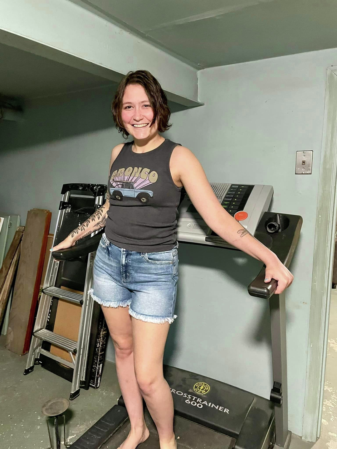 Cassie Wolfe, smiling and standing on a treadmill