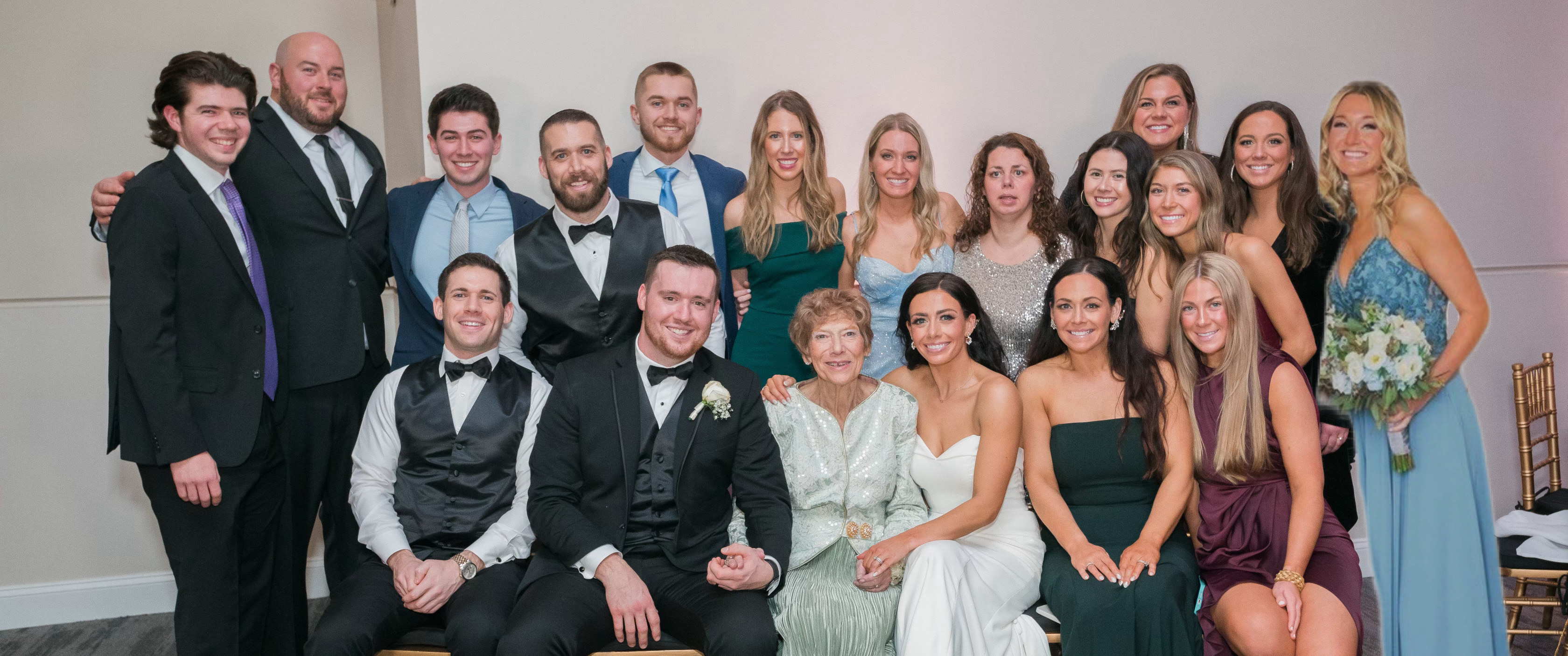 A large group photo of a wedding party, with 85-year-old Norma McPeak at front and center