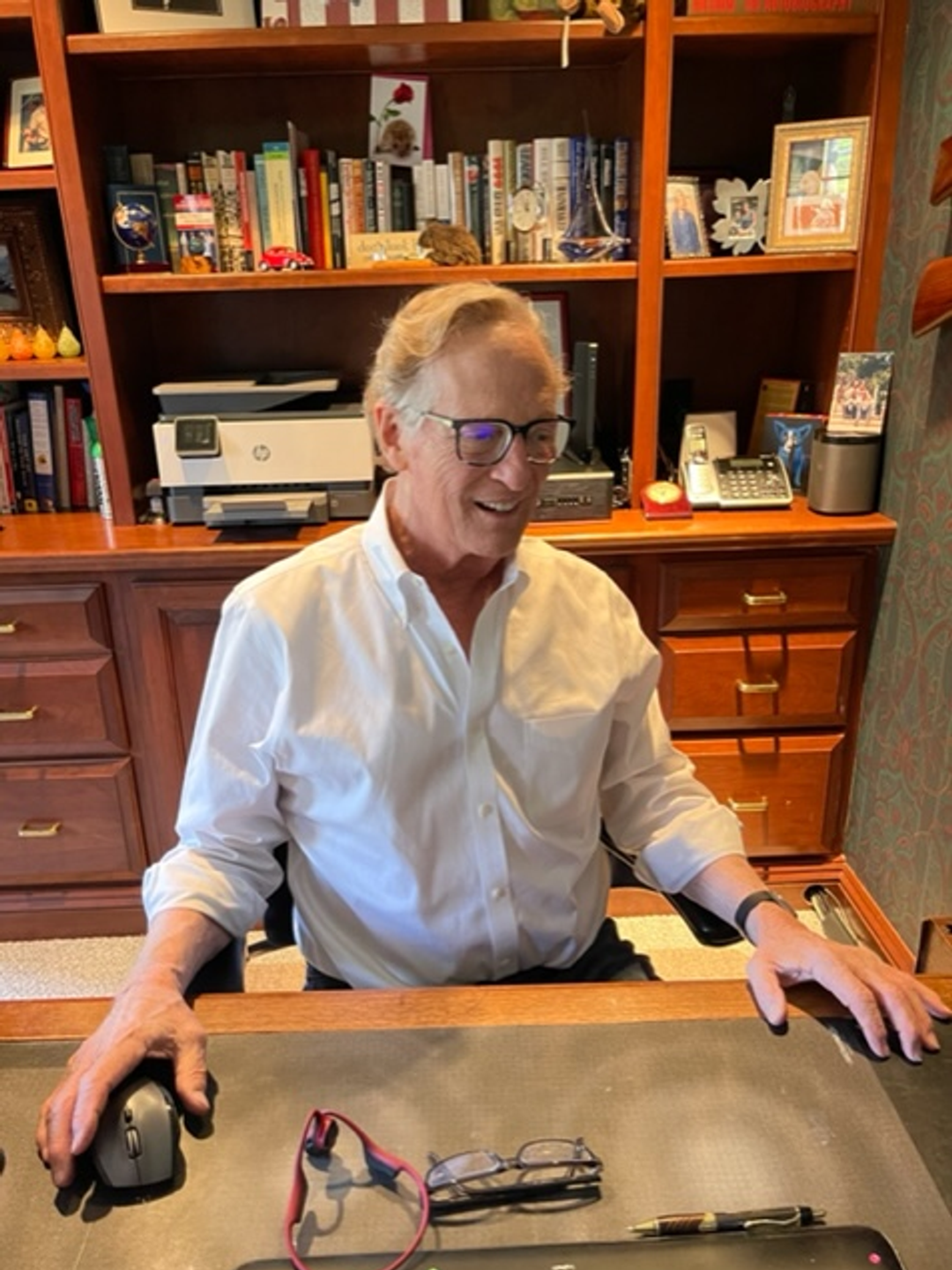 Kim Day sits at his desk in his office at home.