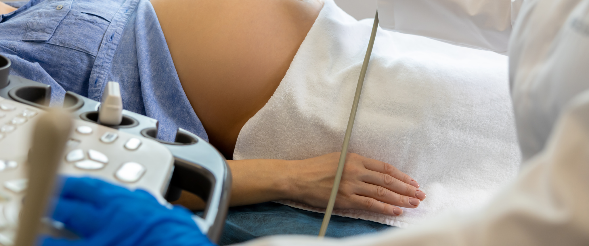 An ob/gyn doctor doing ultrasound on pregnant woman