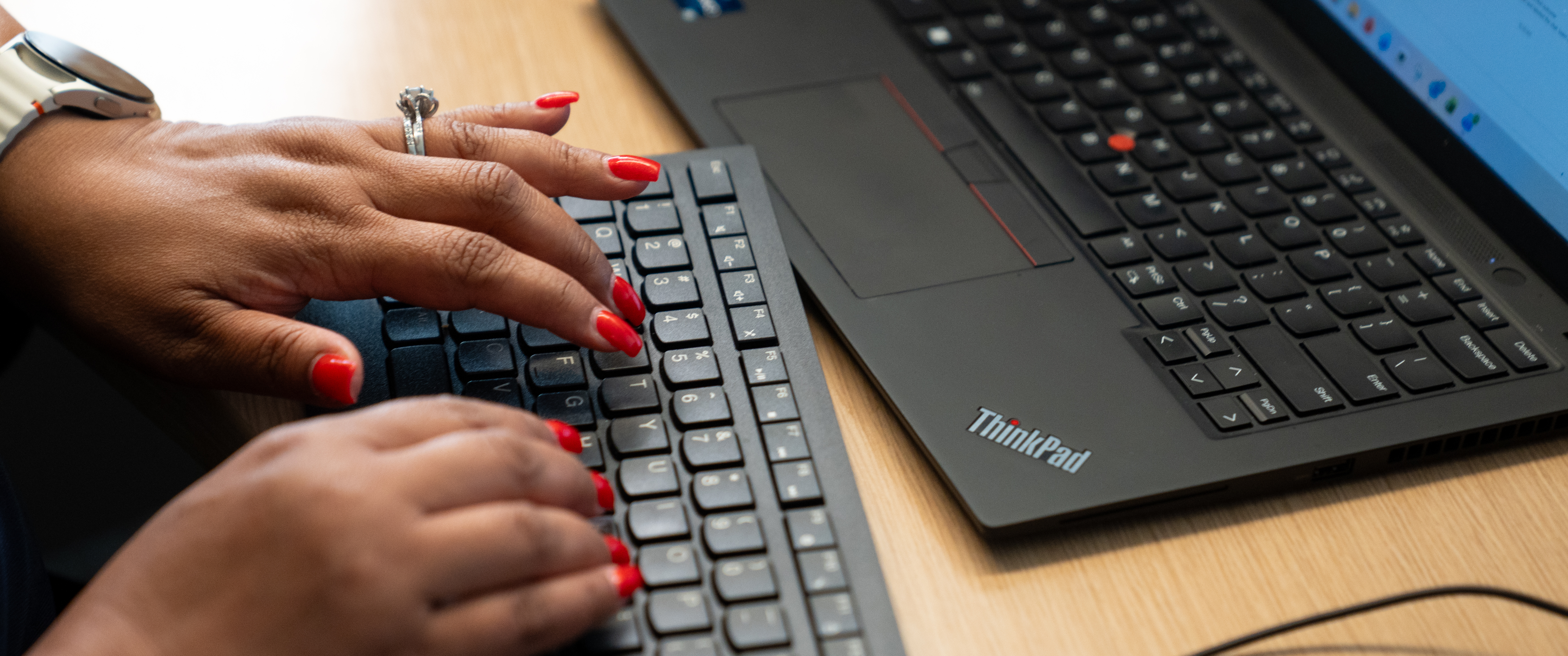 Hands typing on a computer keyboard