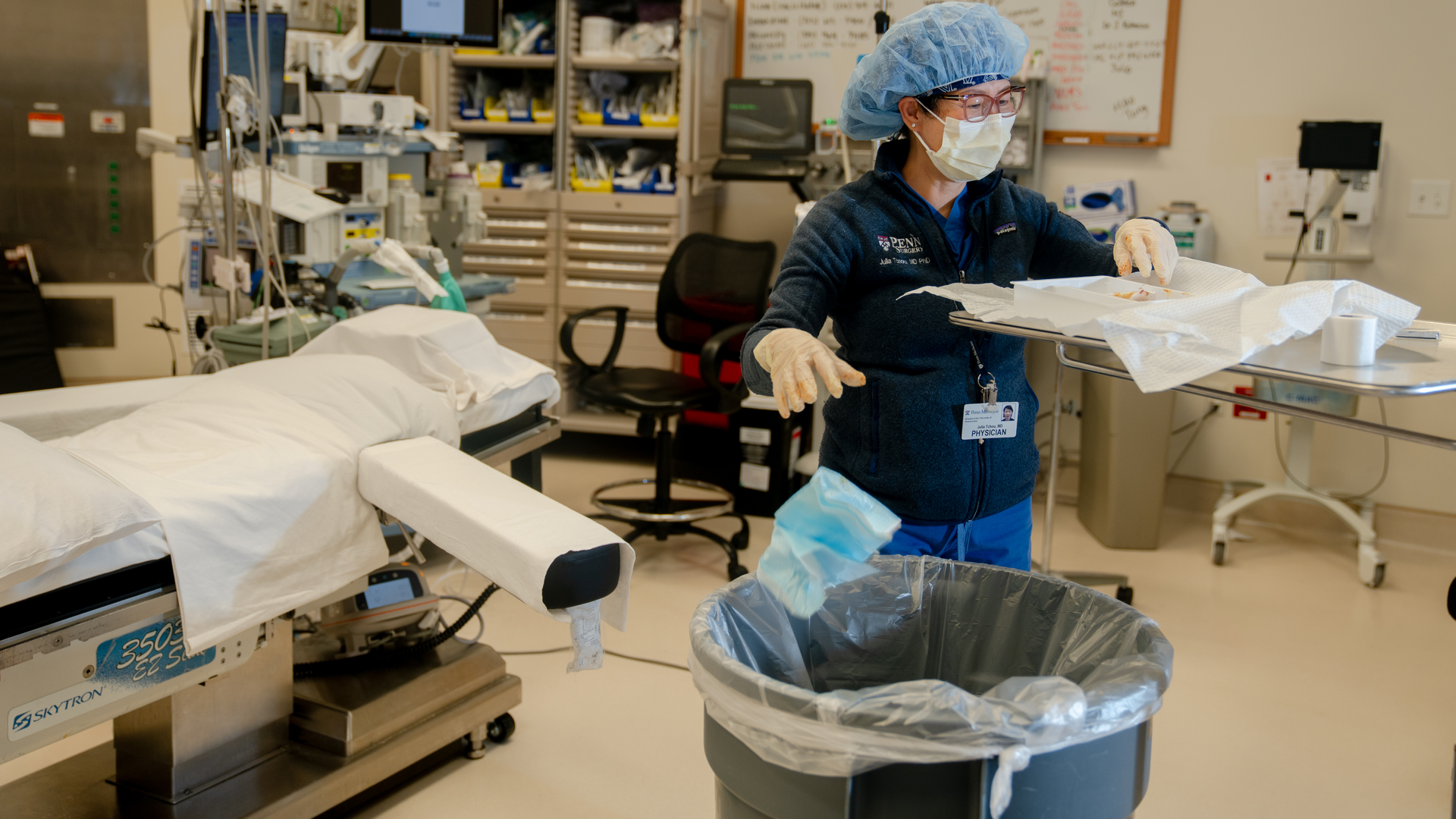 Physician Julia Tchou, MD, PhD, FACS throws away medical waste