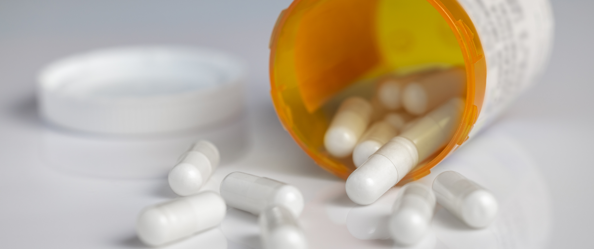 An orange container of white pills