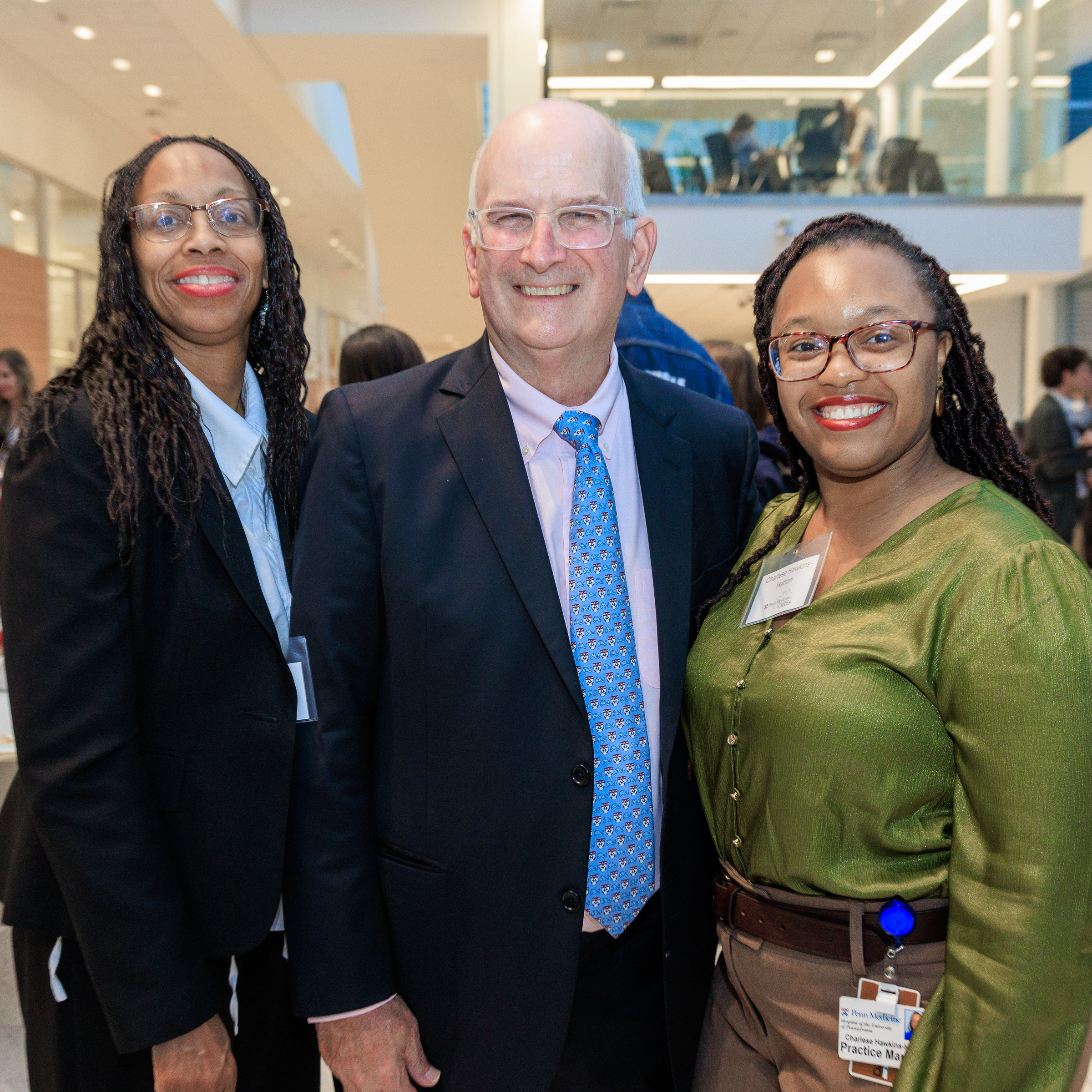 Kevin Mahoney stands with two employees