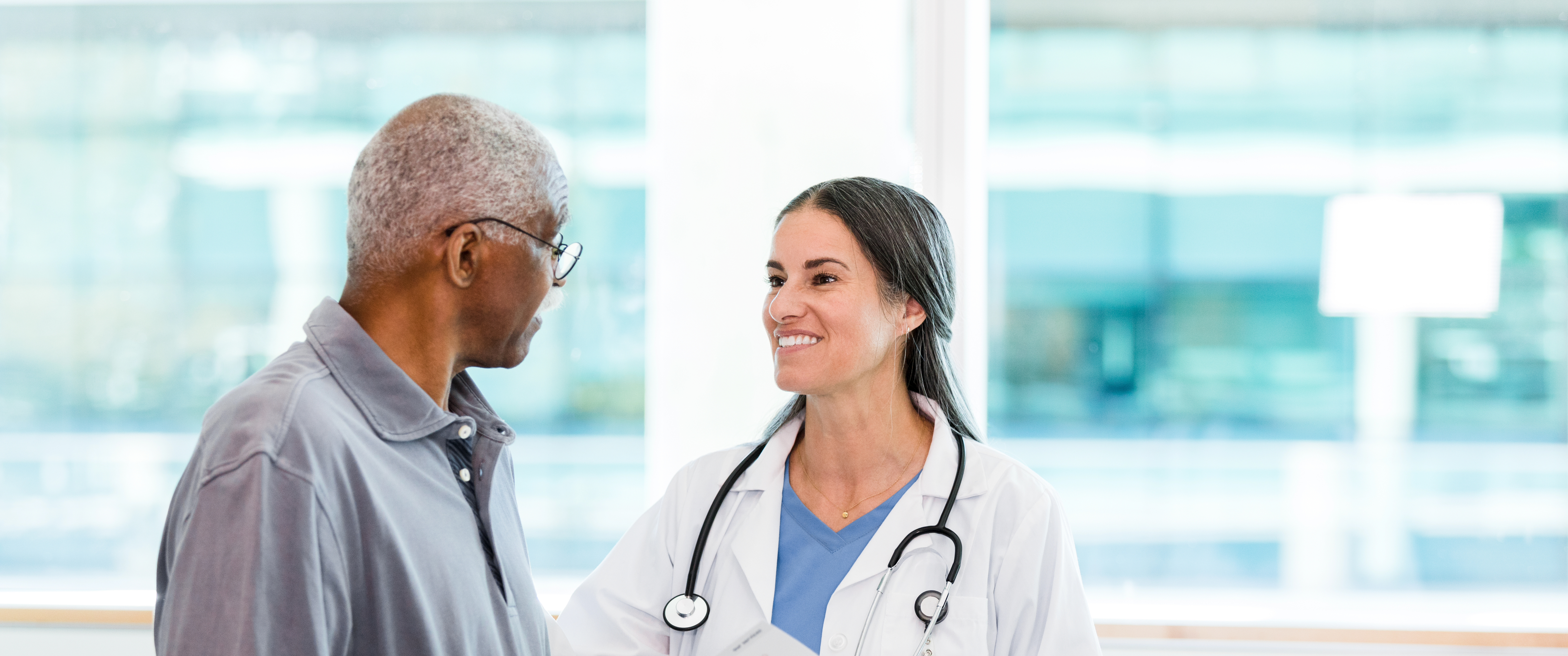 Female doctor and senior male patient in discussion