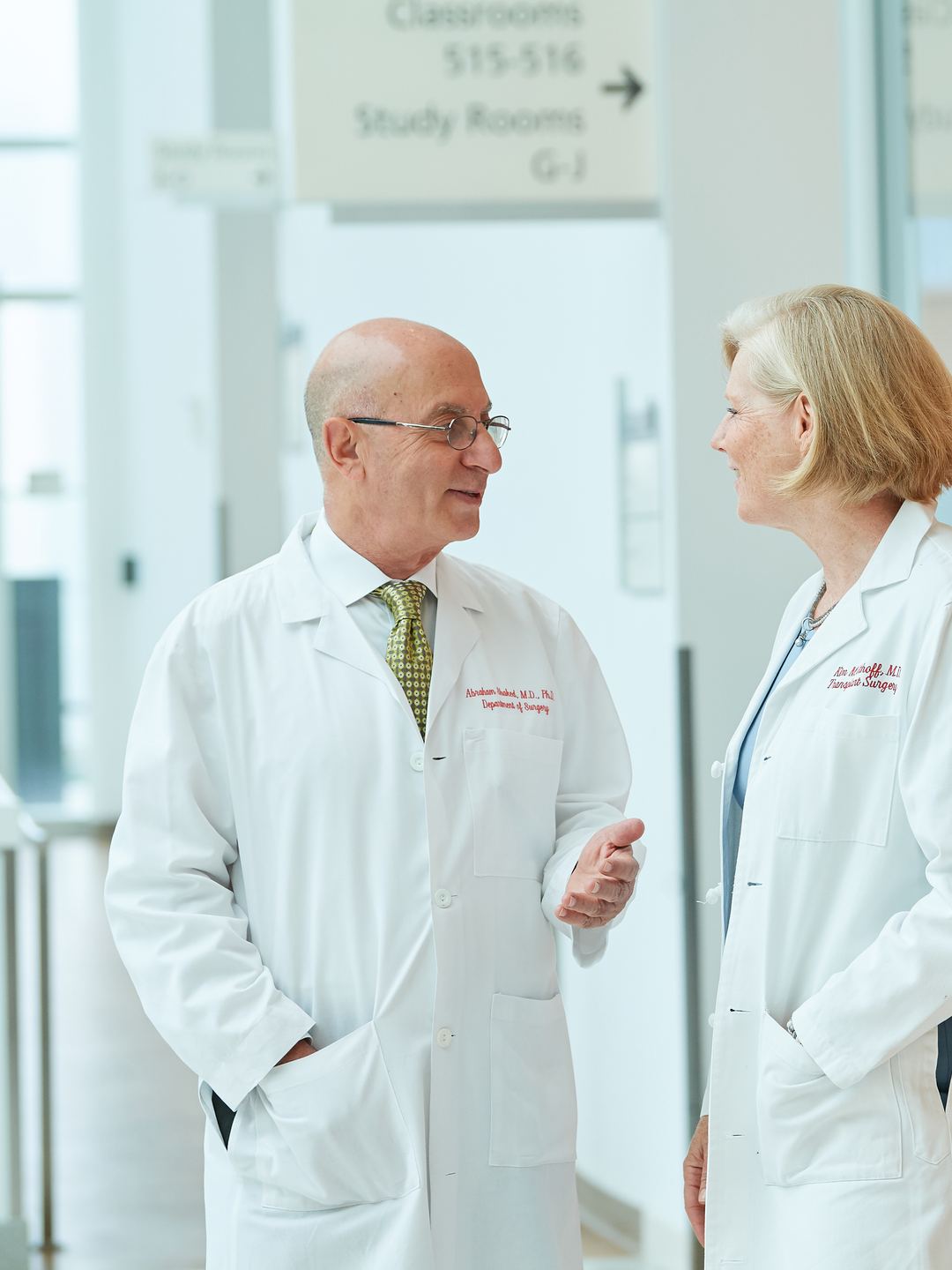 Director of the Penn Transplant Institute, Abraham Shaked, MD, PhD, and  Chief of the Division of Transplant Surgery, Kim M. Olthoff, MD, talking in the hallway at the Perelman Center for Advanced Medicine
