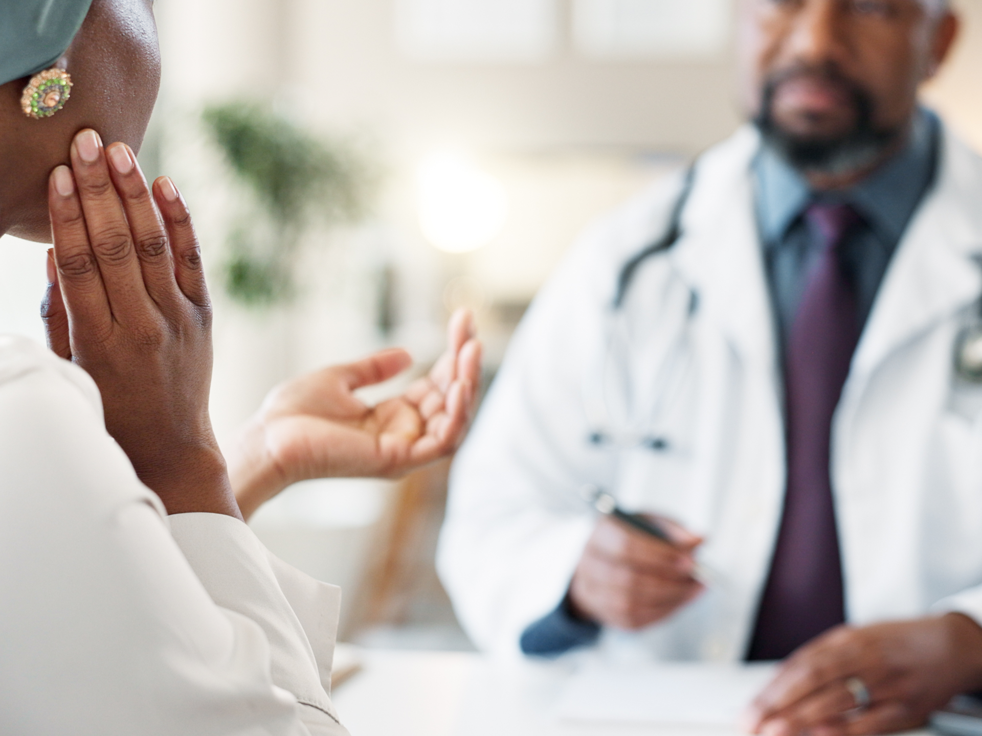 Patient consulting with doctor about jaw pain and tmj treatment.