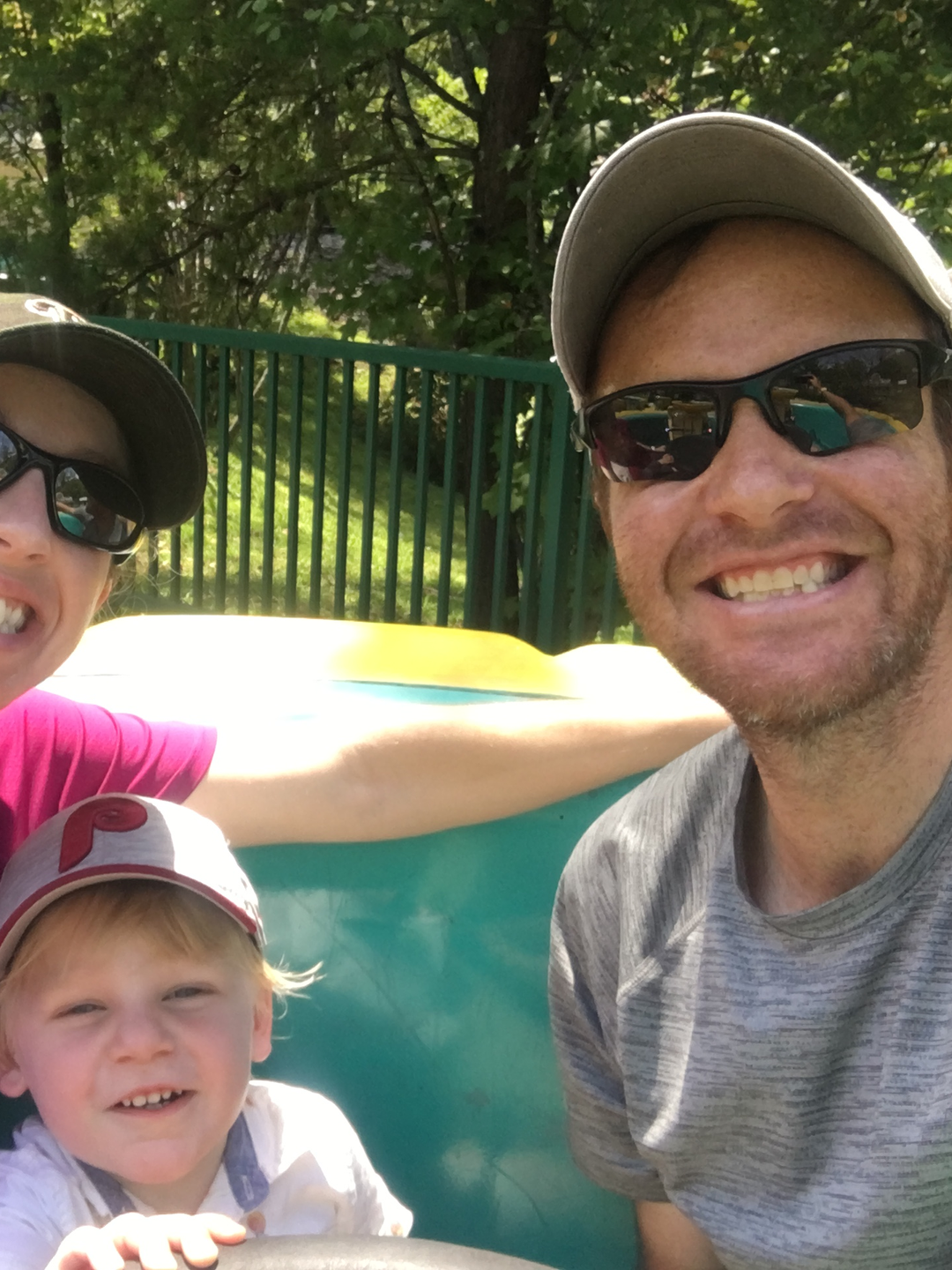 Chris Naimo, Caitlin Naimo, and baby CJ smiling in a park