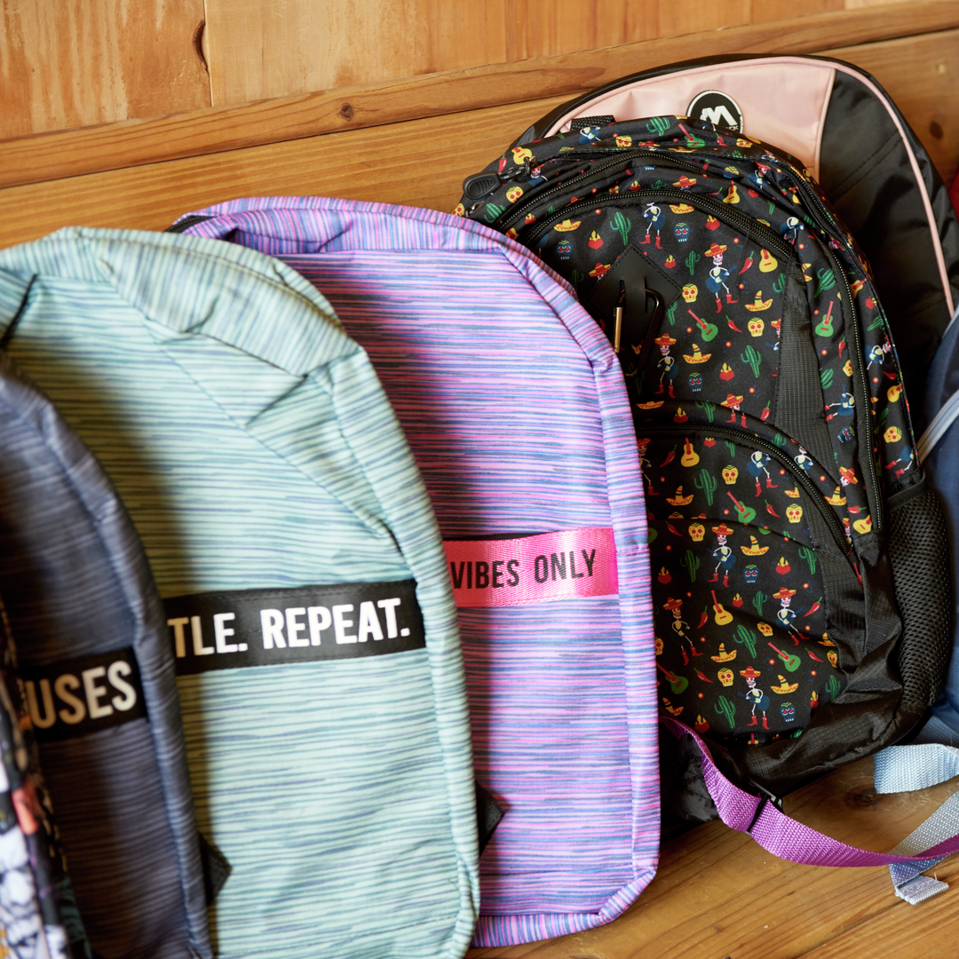 An array of colorful new backpacks in a row