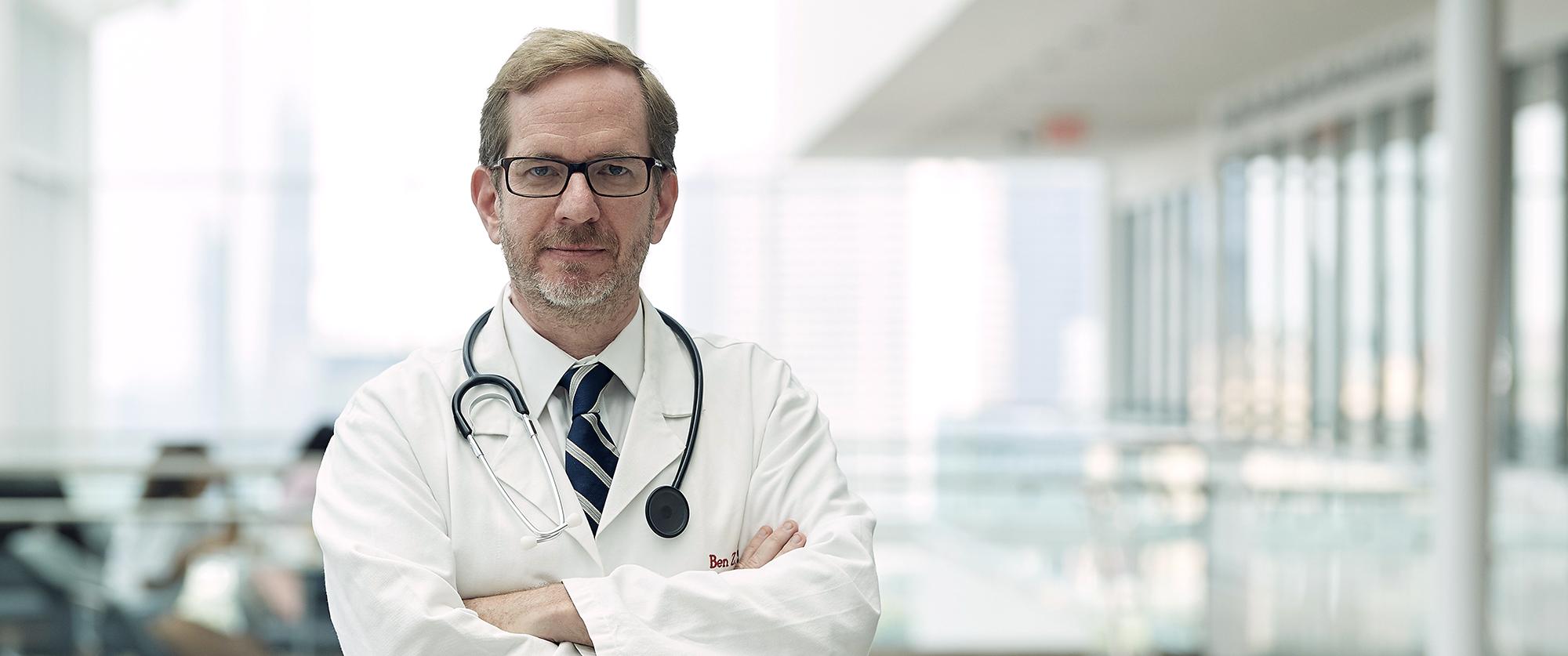 Portrait of Ben Stanger in a white coat
