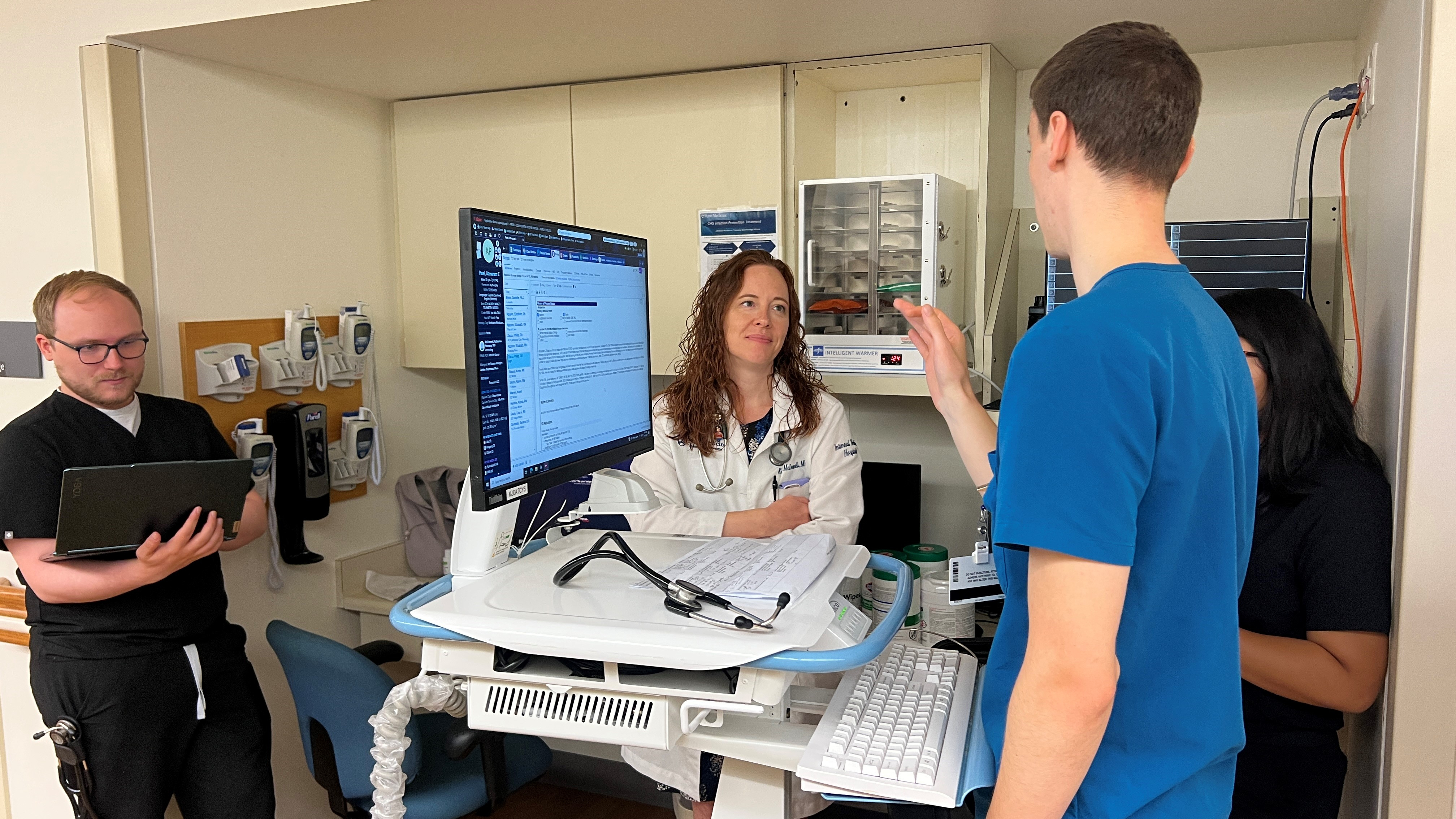 A resident presenting a patient case to a teaching doctor at Chester County Hospital