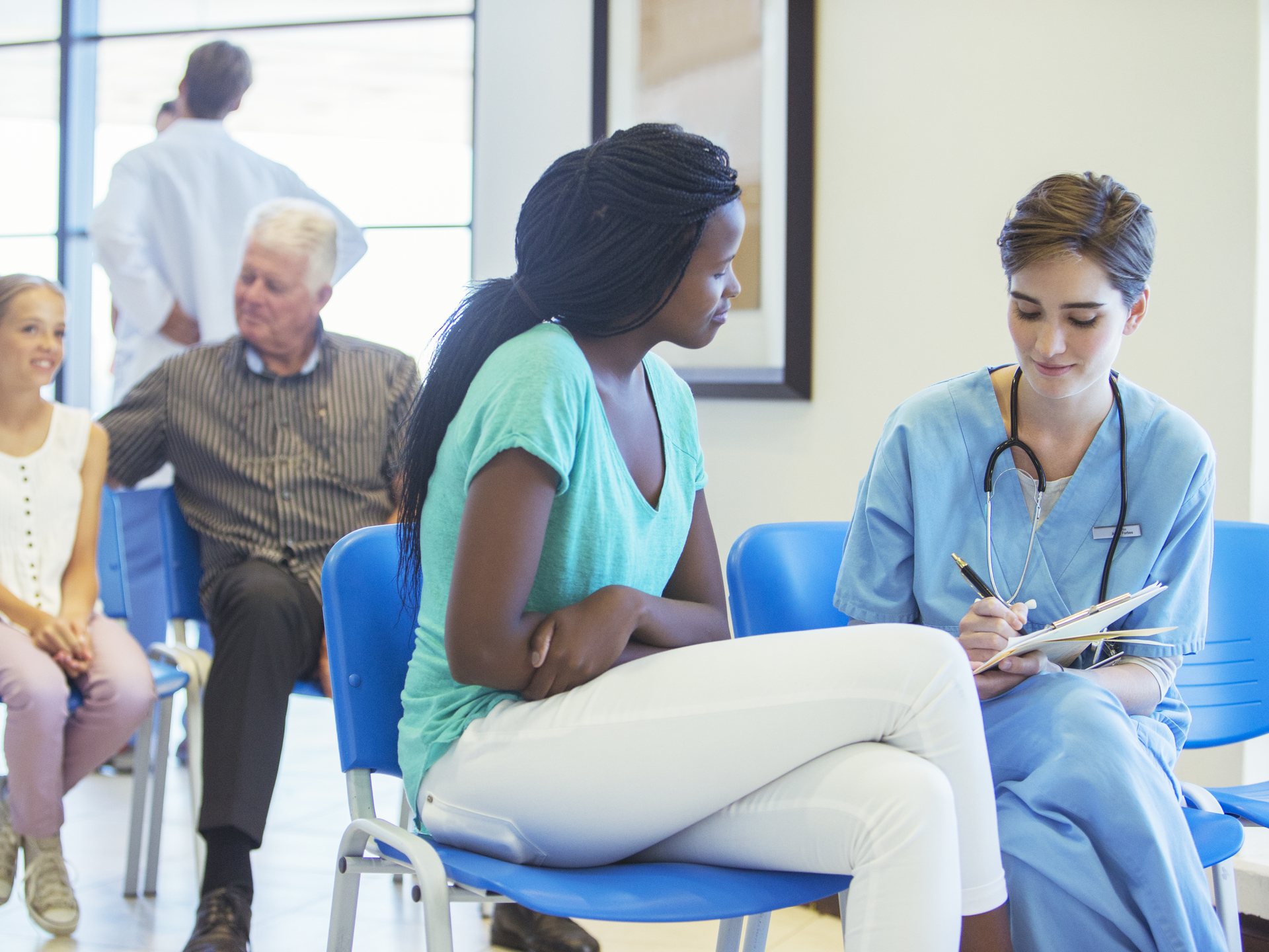 Nurse and patient talking in hospital