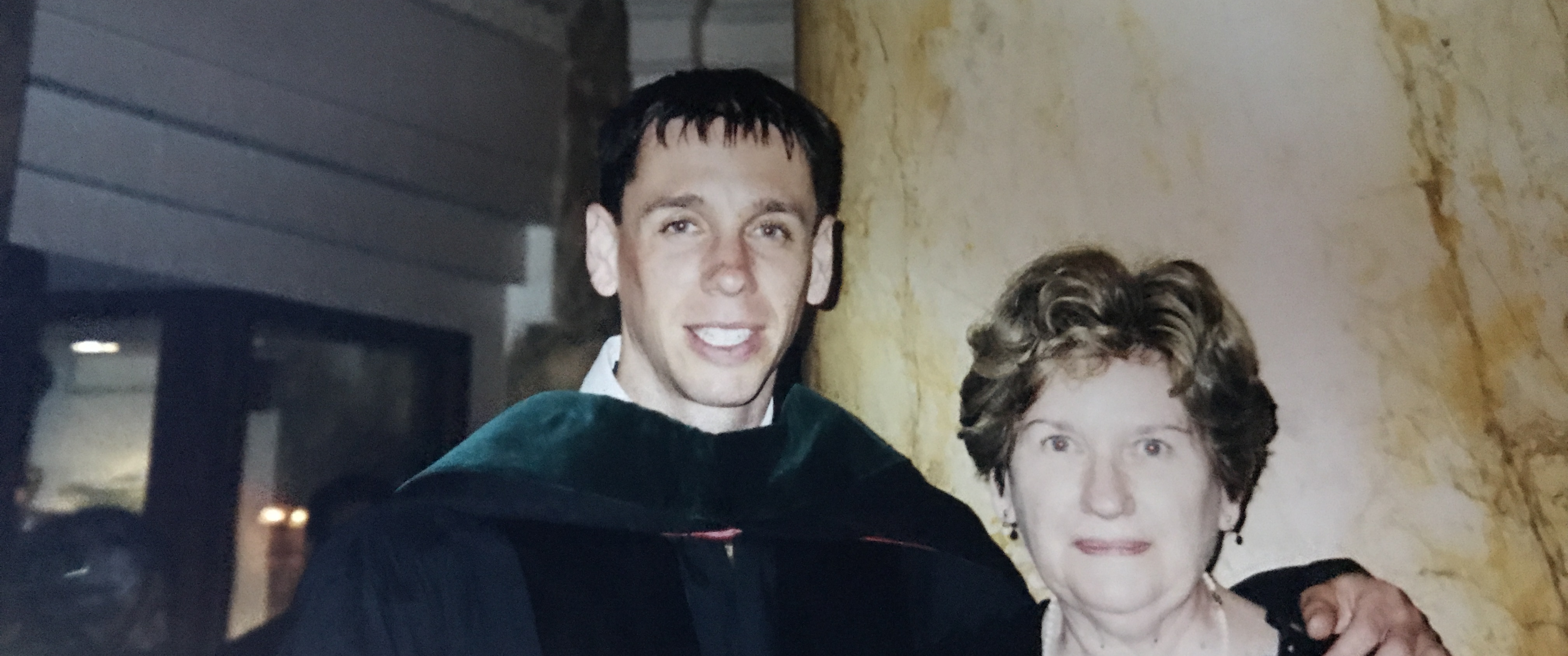 Gregory Beatty as a young man in graduation garb, with his mother