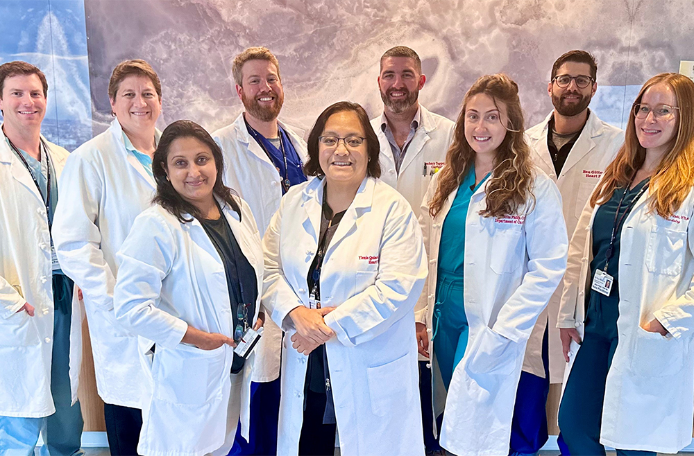 smiling group of people in lab coats