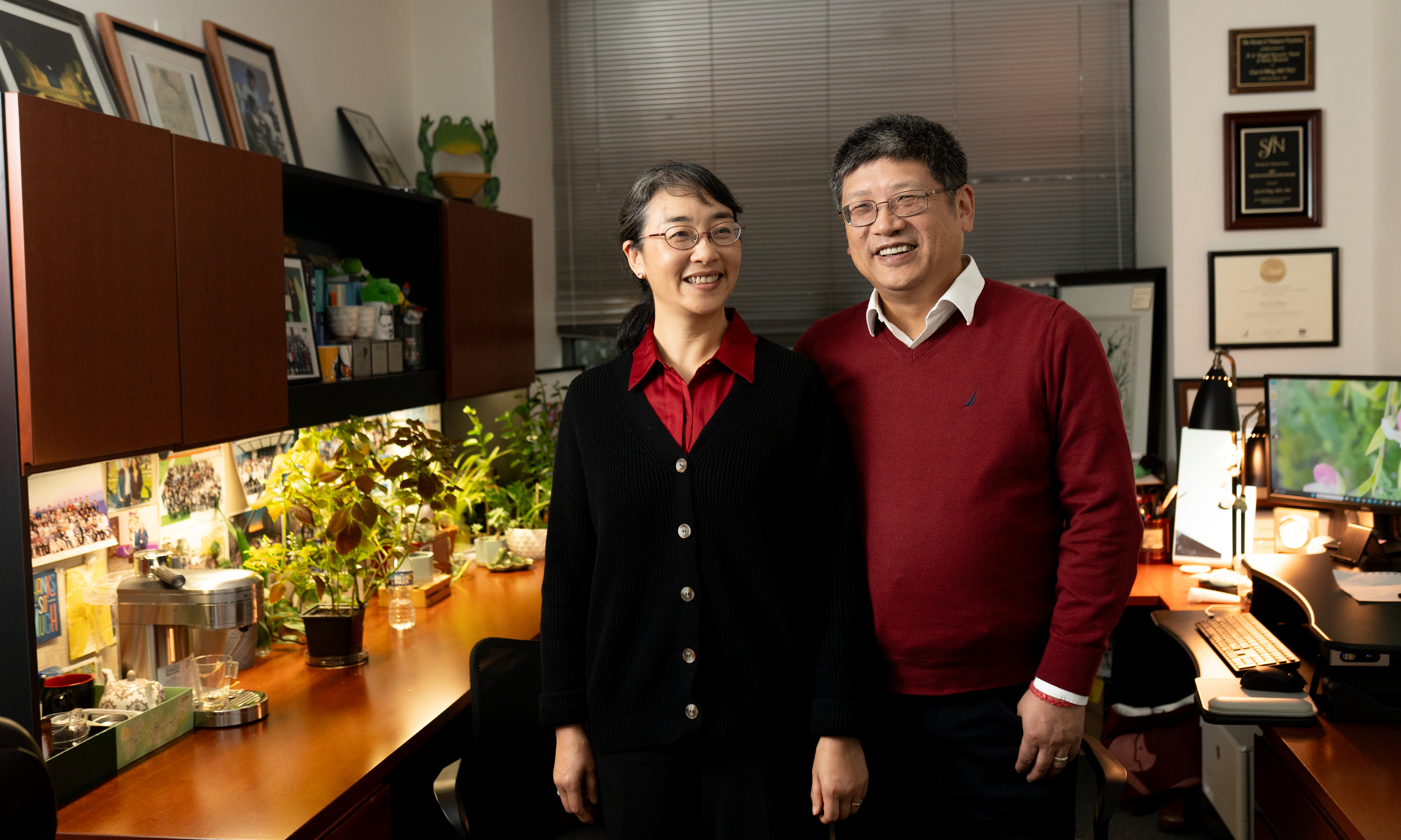  Guo-li Ming, MD, PhD, and Hongjun Song, PhD, stand smiling in a relaxed moment in an office