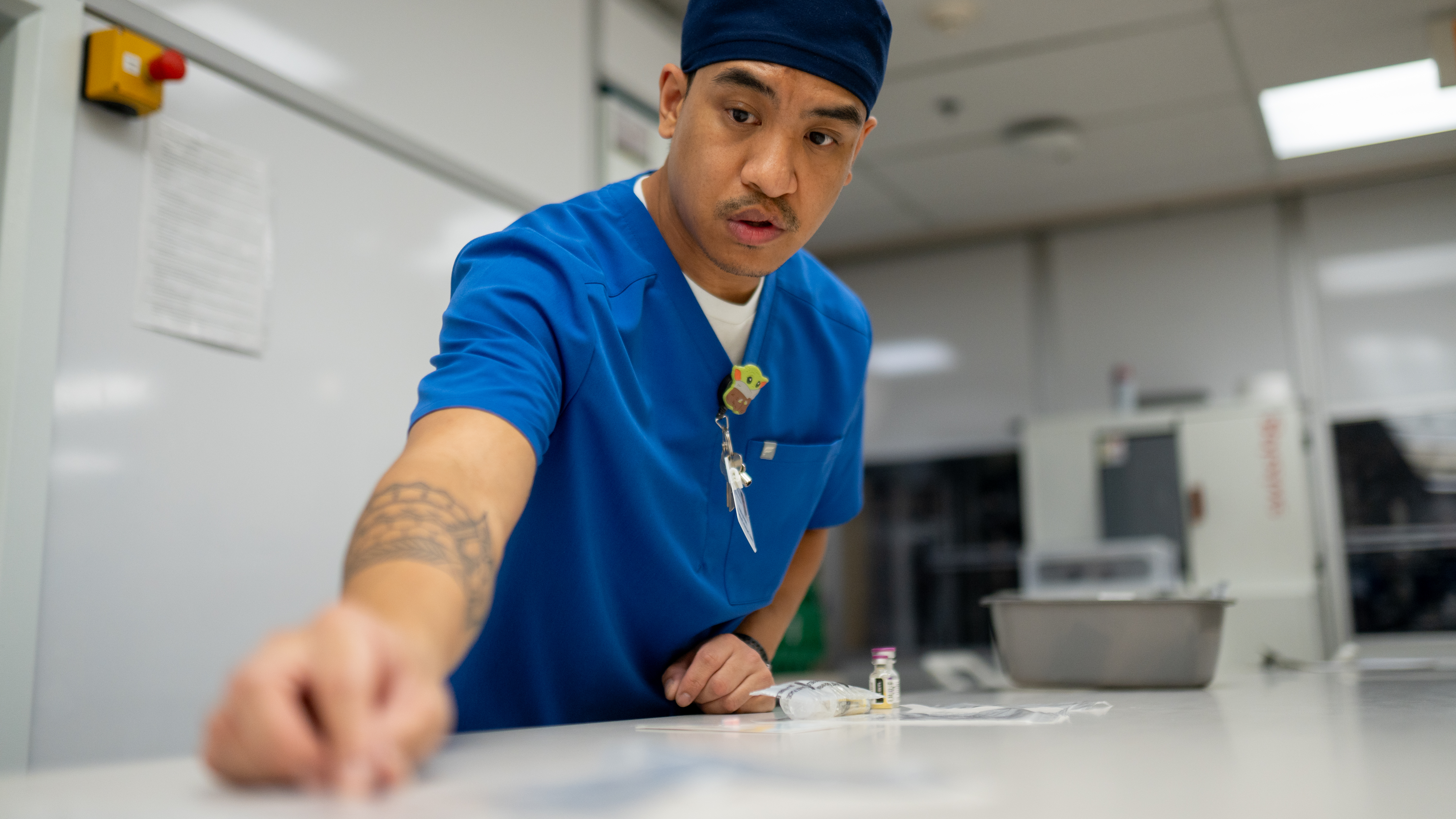 Pharmacy Tech Trainee Rodrigo Mateo double- checking a label in the inpatient pharmacy at Penn Presbyterian Medical Center