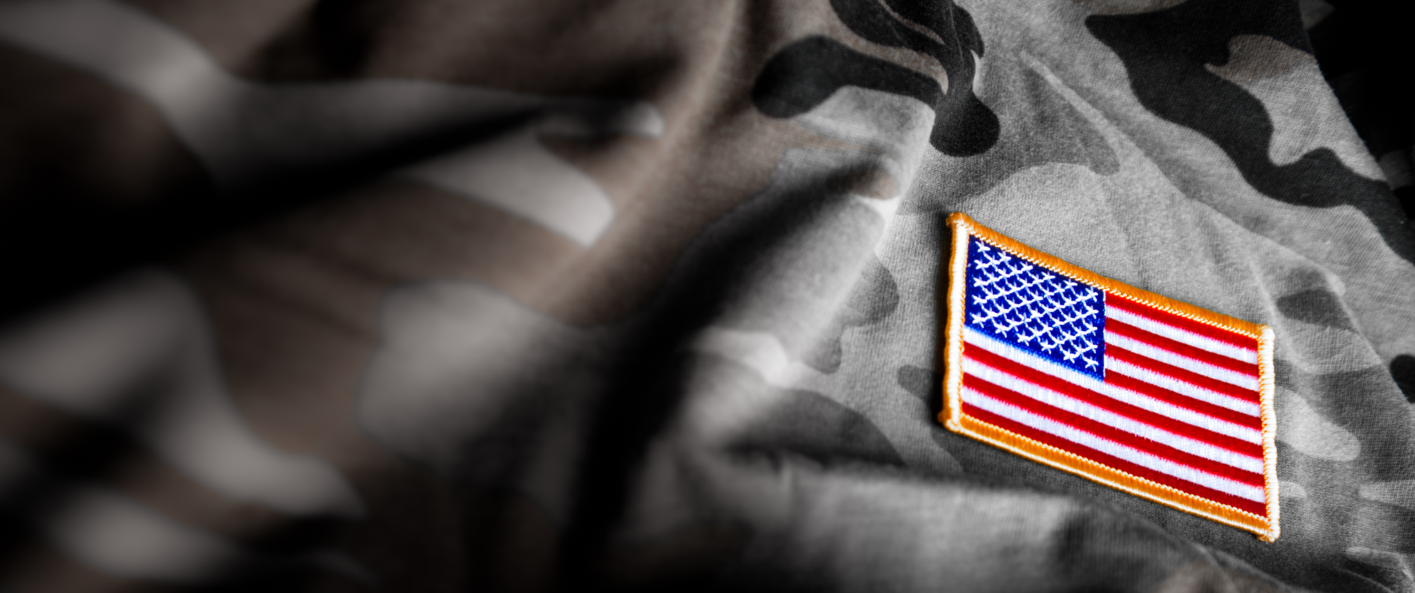 American flag patch on camouflage fabric