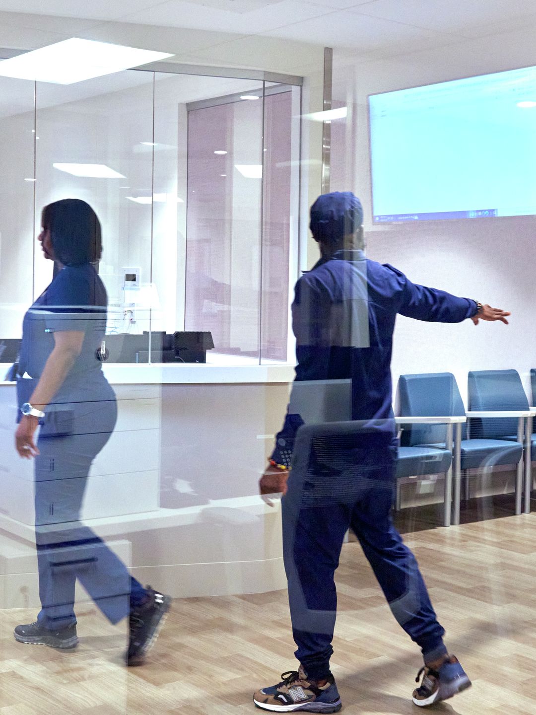 Two medical personnel walking through the Cedar Crisis Response Center waiting room.