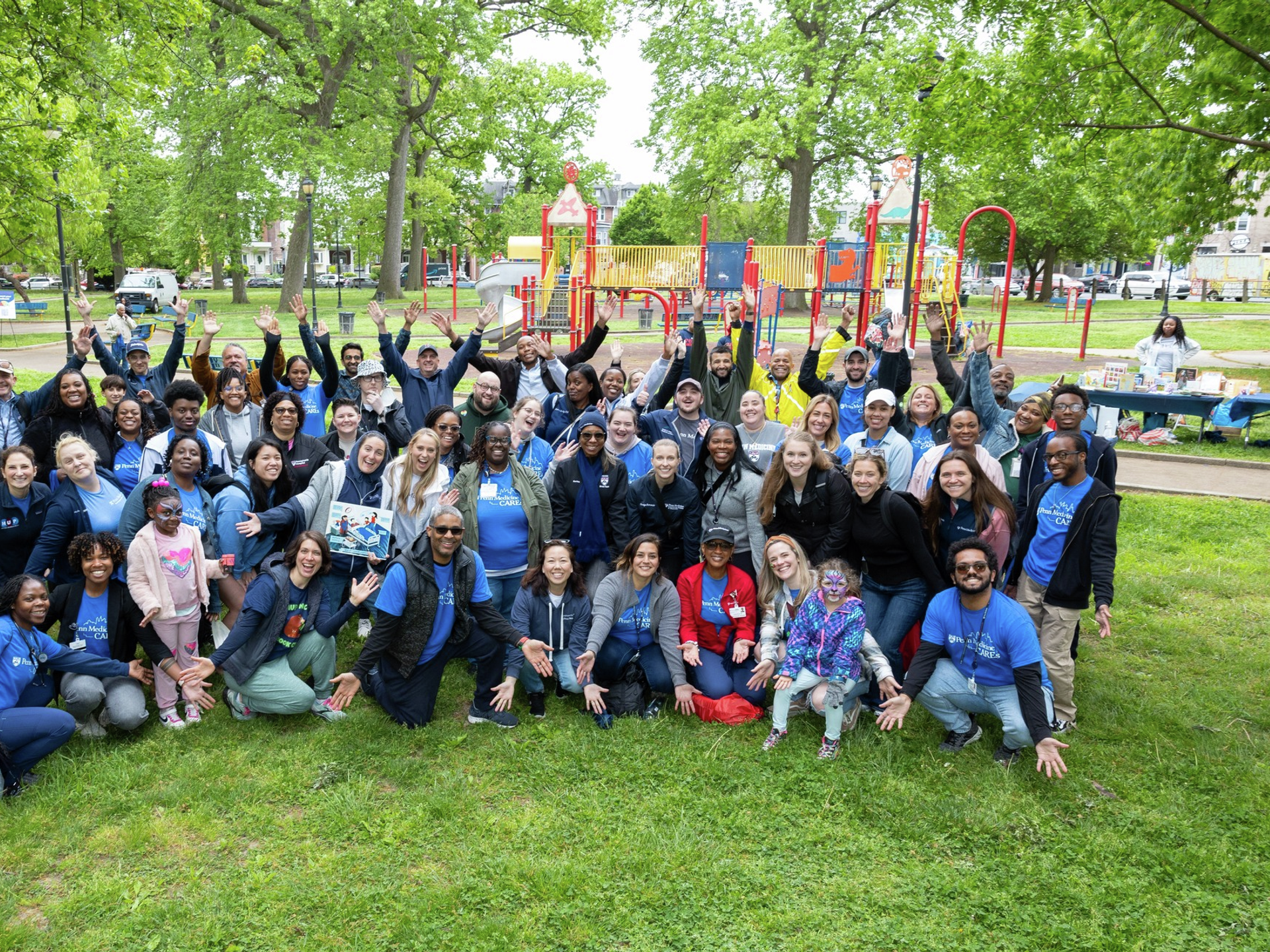 Penn Medicine nurses and local community members posing in a group photo at Community Day in West Philly to kick off Nurses Week 