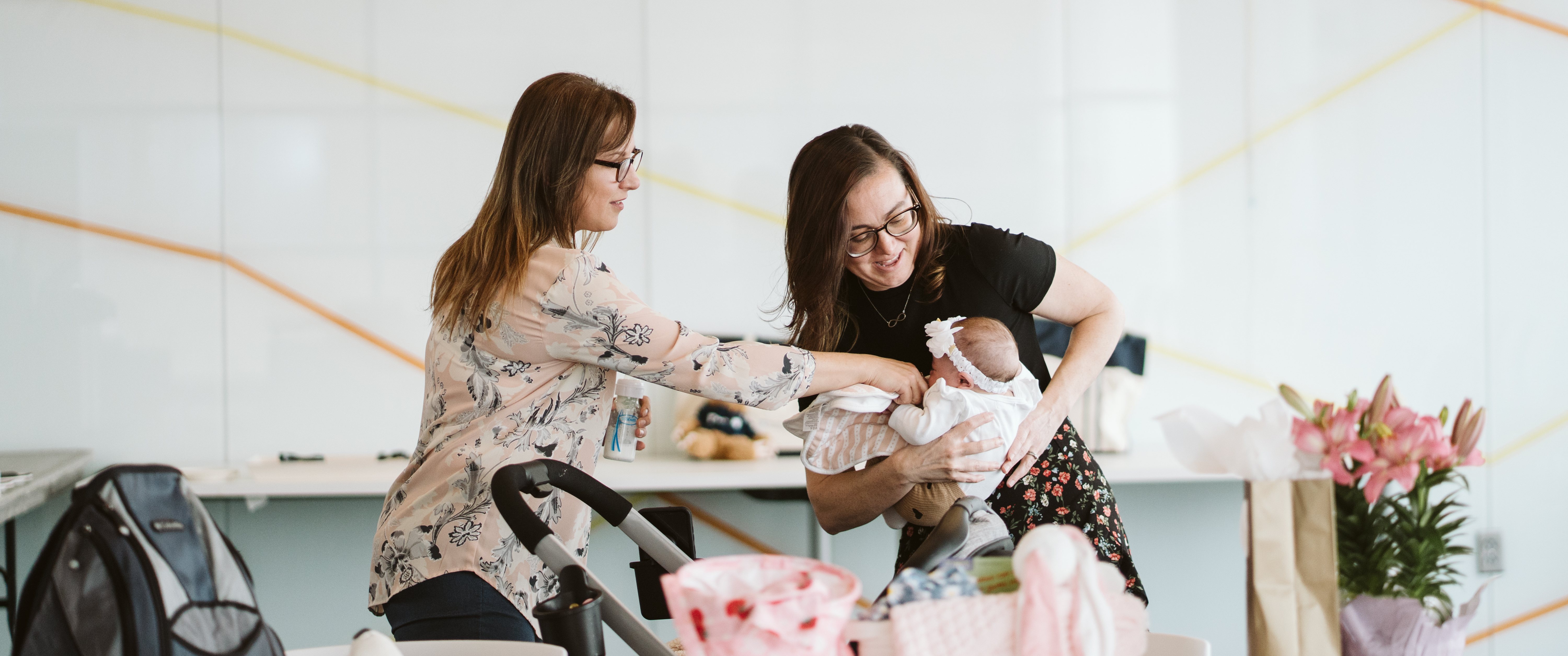 Ashley Christman and Justyna Ruiz both dote attention on baby Adriana