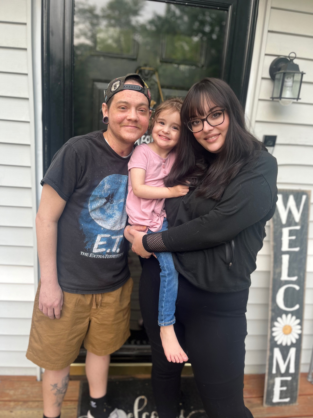 Joey Porch with his wife and child on their front porch