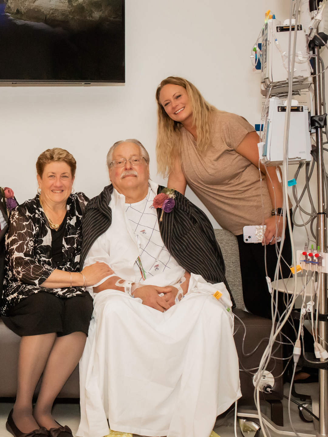 Keith Maggs, second from right, sits for a photo with his newly married son and daughter-in-law, and other family members