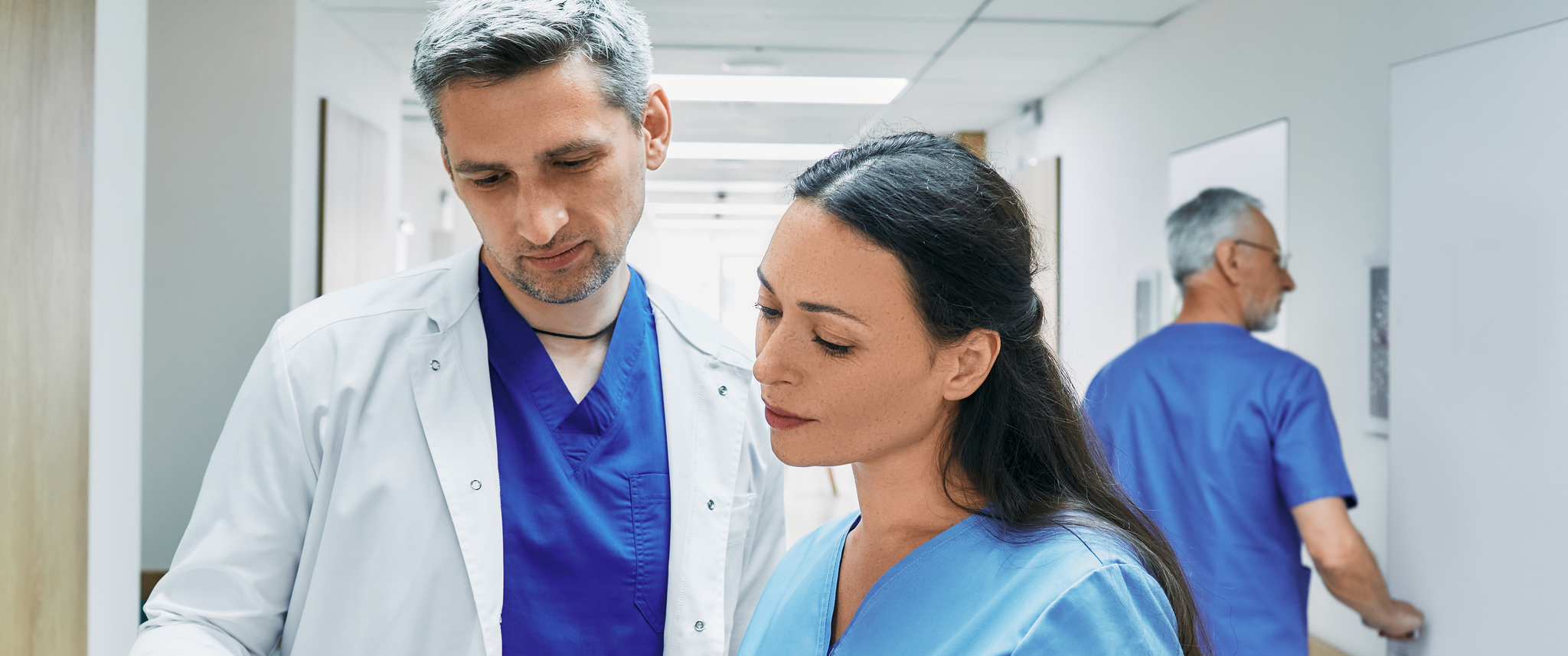 Experienced cardiologist with female nurse analyzing patient cardiogram. Department of cardiology at hospital