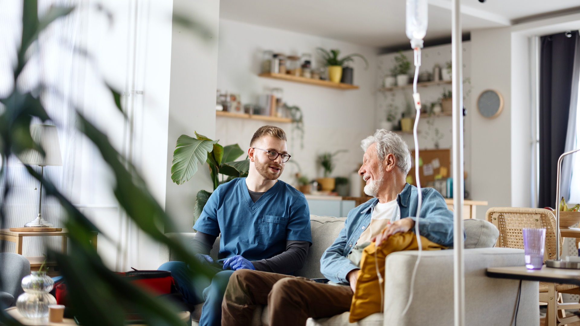 Senior man talking with his caregiver at home