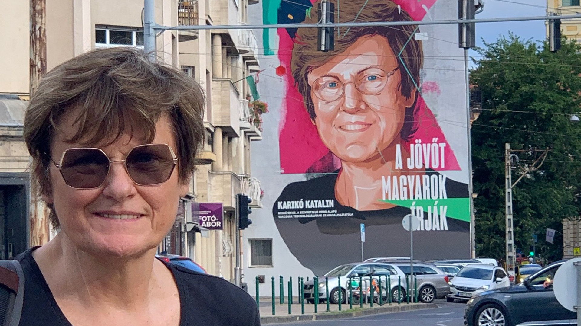 Katalin Kariko standing in front of mural in Hungary