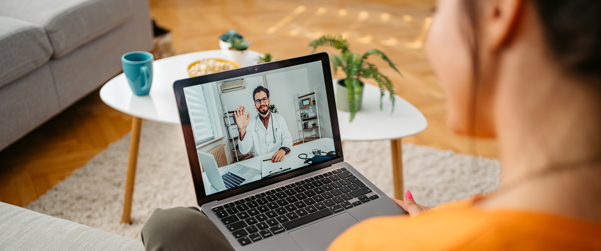 Patient having a doctor's appointment online over the laptop, while sitting at home
