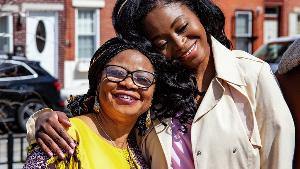 Mariam Olujide embraces her mother as they celebrate outdoors