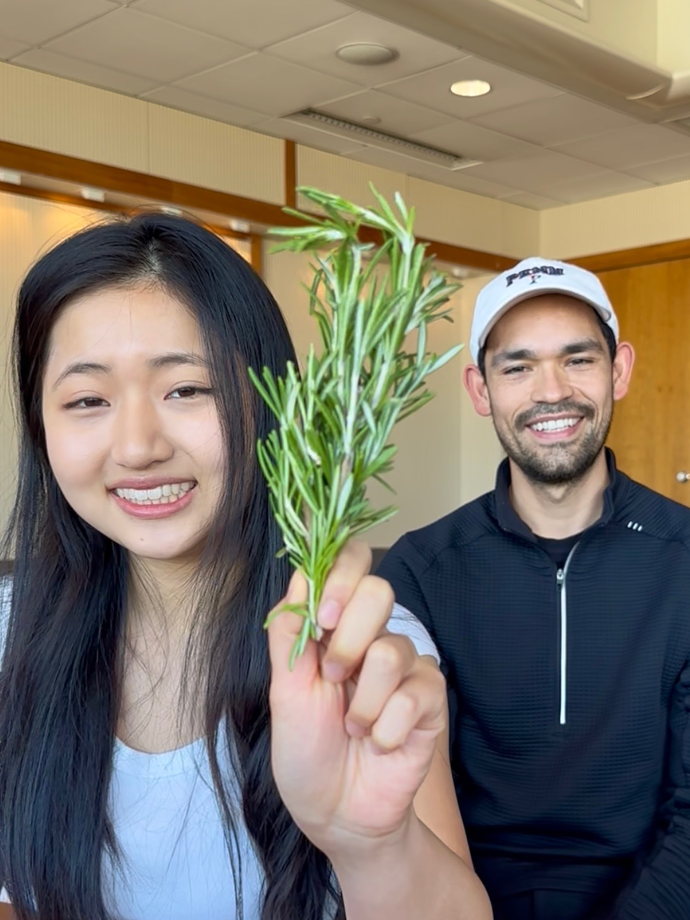 Jiayi Pang, on left, holding rosemary, and Emmanuel Rapp Reyes, on right, smiling