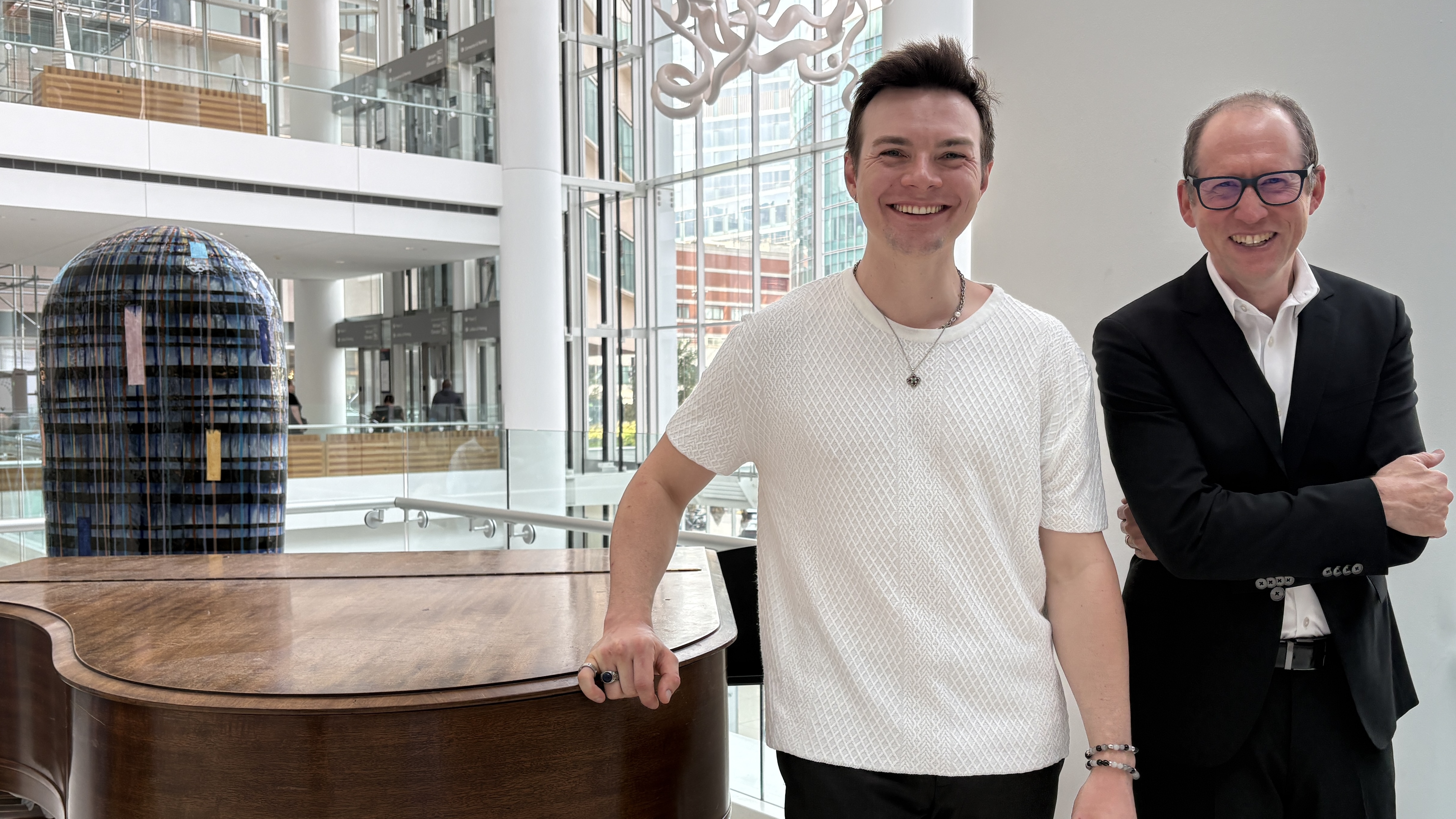 Ashlan Willett and Aaron Levy stand together, smiling, in the Perelman Center for Advanced Medicine