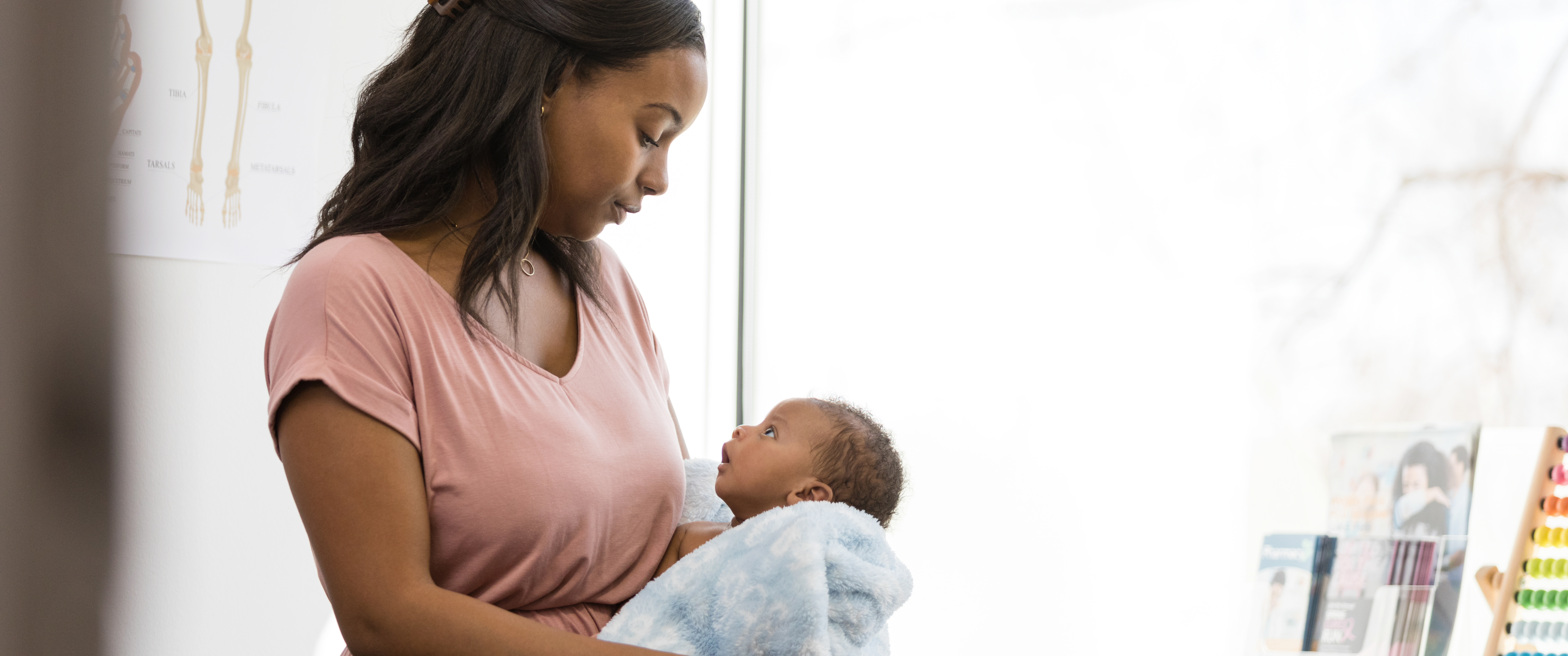Black mother looking down at baby in arms