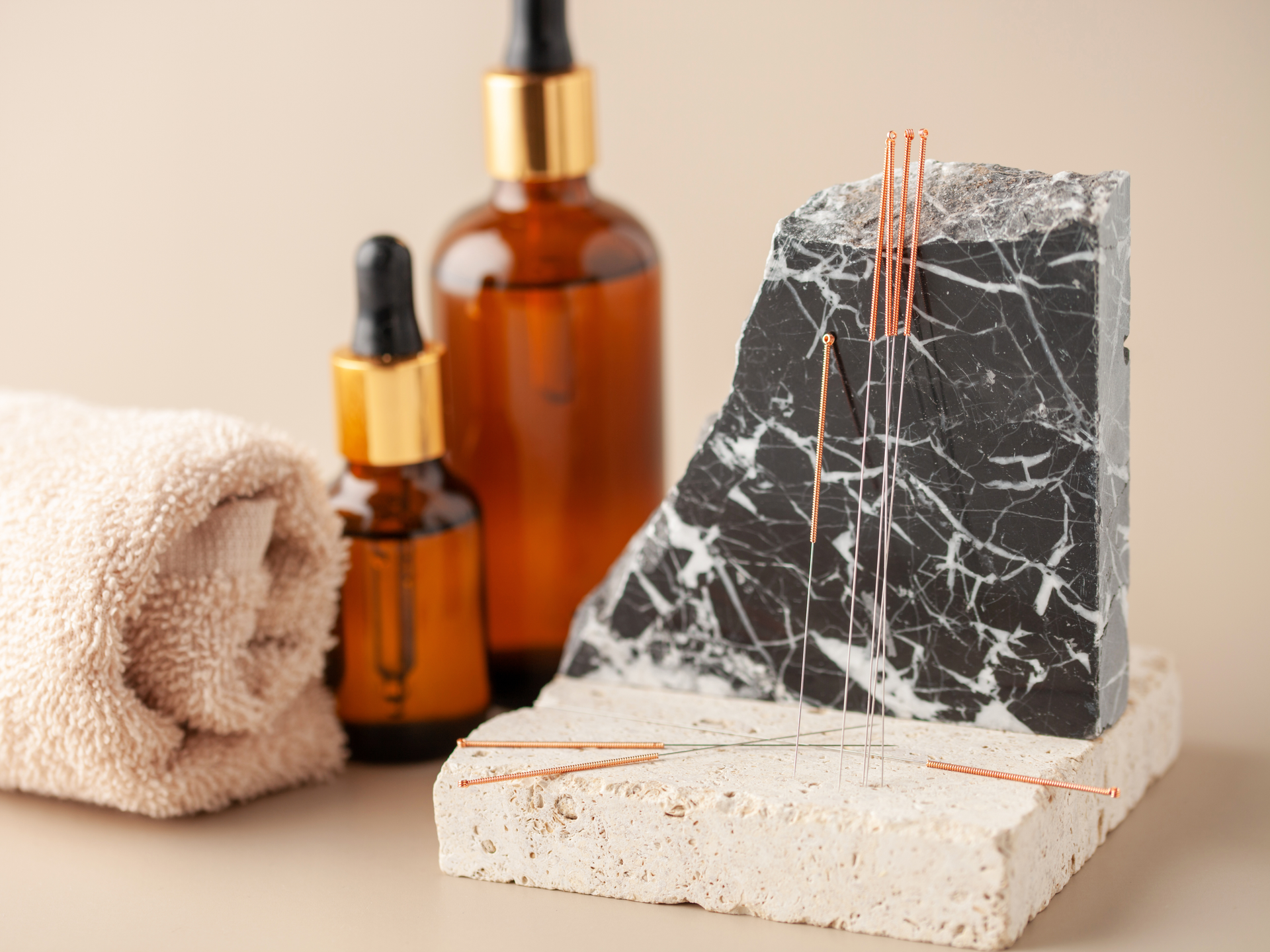 acupuncture needles, towel, and massage oils