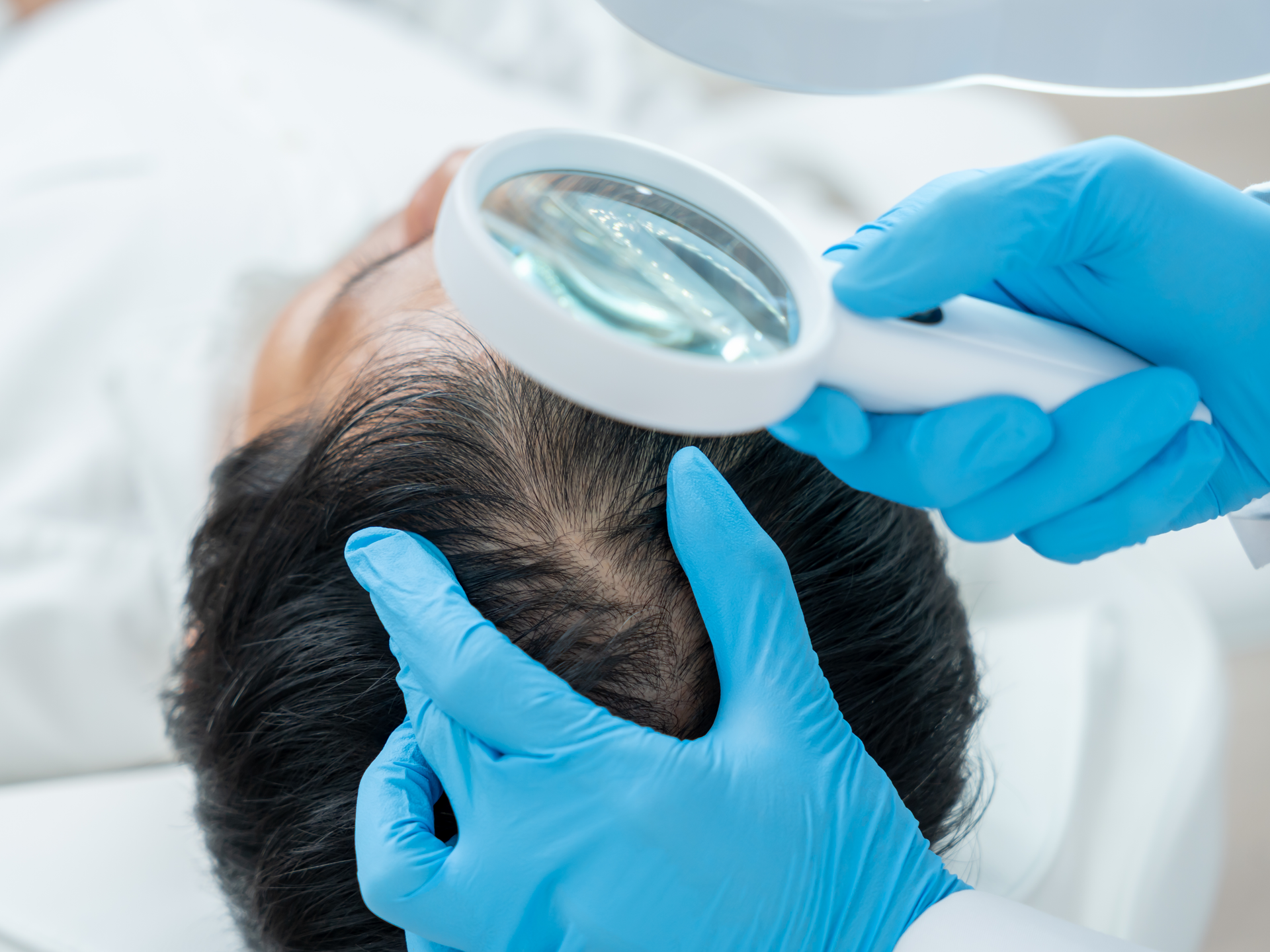 Dermatologist examining hair and scalp health