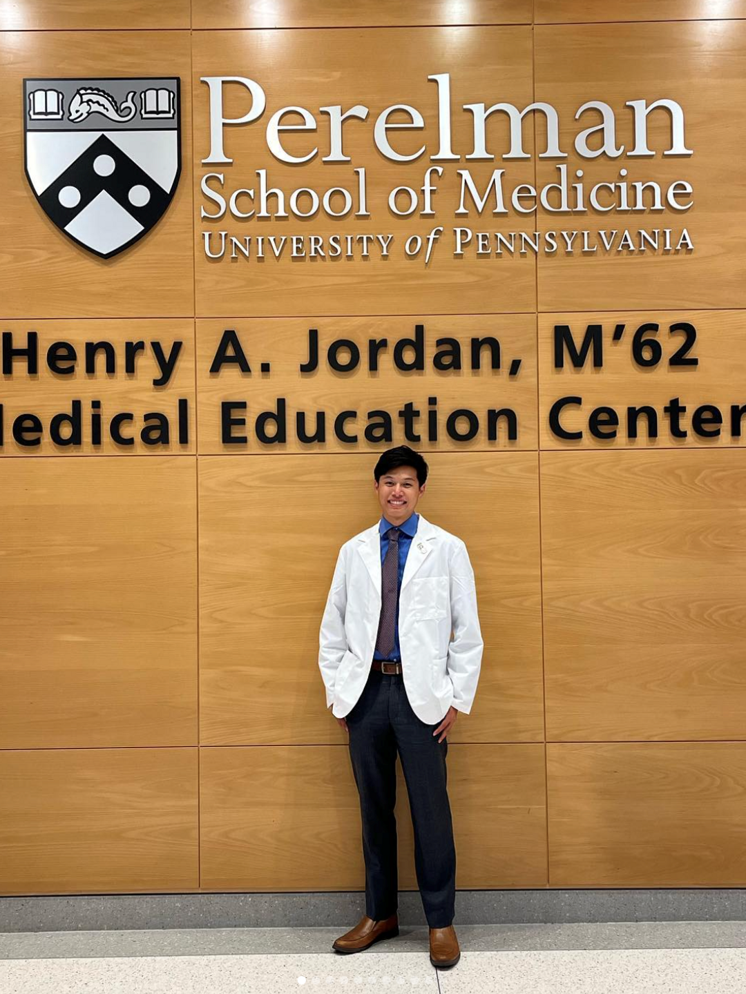 Jonathan Szeto, wearing a short white coat in the Jordan Medical Education Center