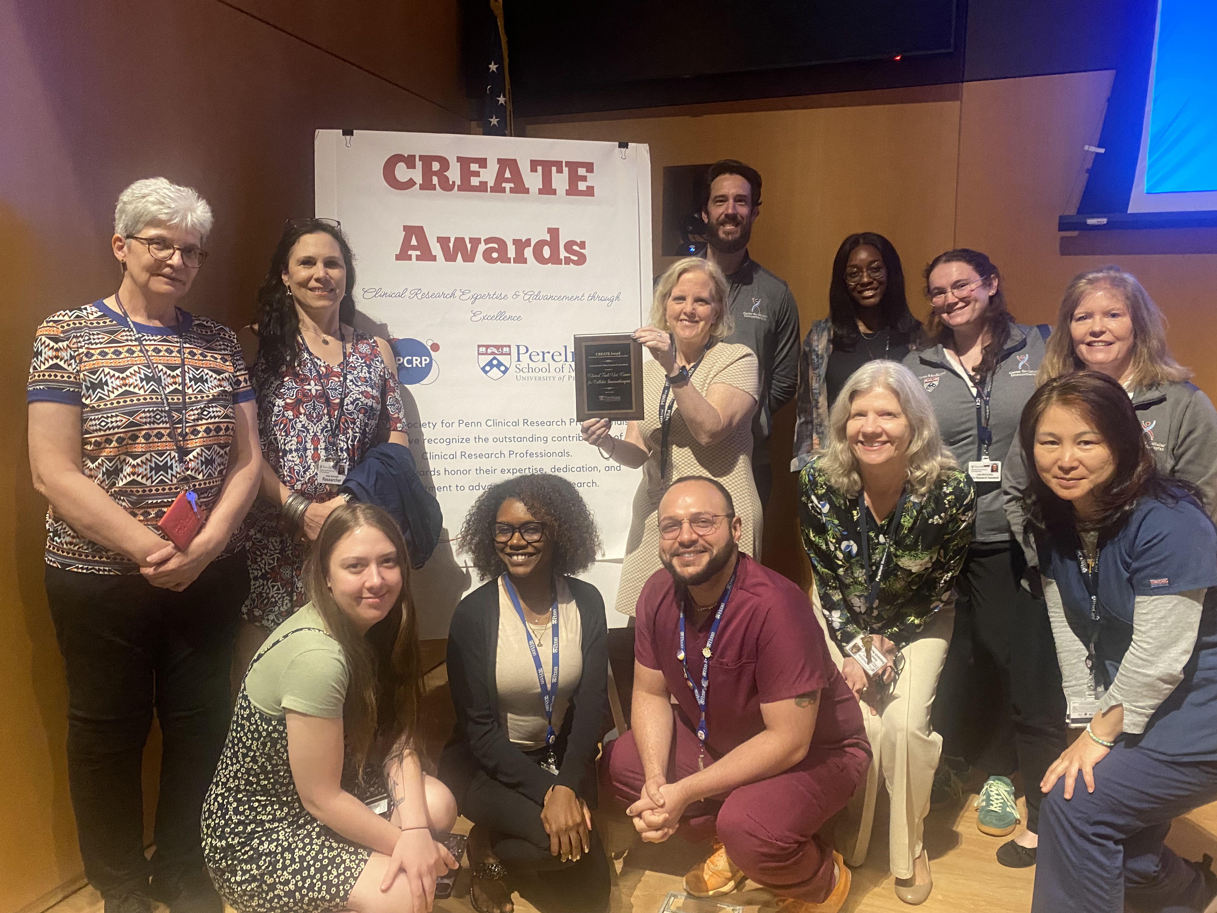 Group photo of the CTU team with their plaque in front of a sign for the CREATE awards