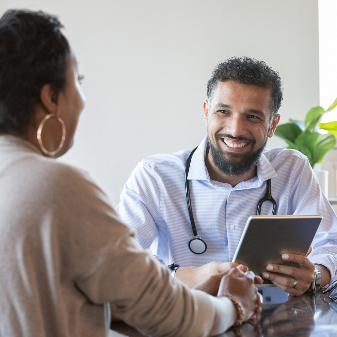 Doctor and Patient at appointment reviewing patient resources about epilepsy