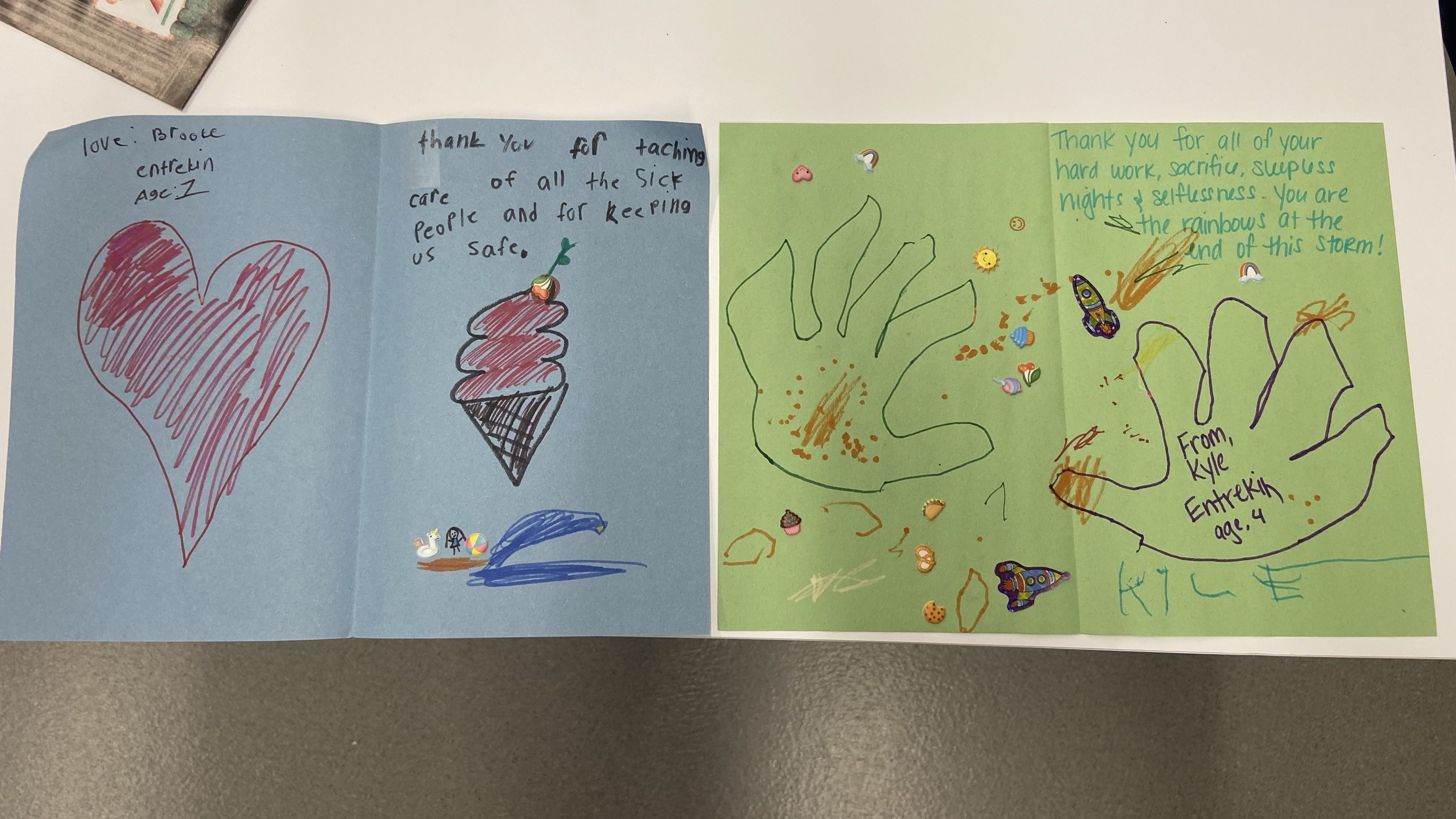 Homemade thank you cards made by children on construction paper with notes of thanks to hospital staff